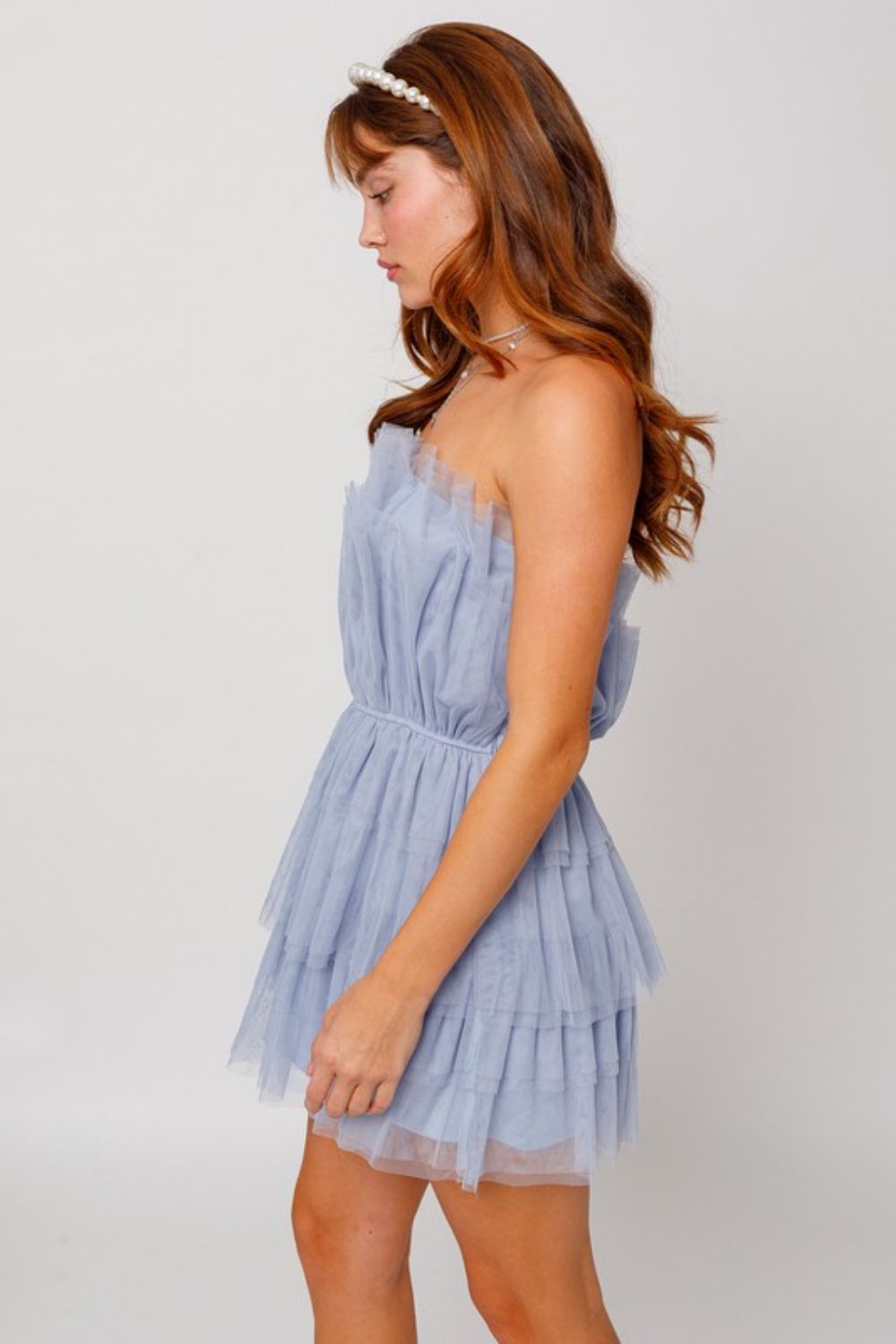 A stylish strapless layered mesh dress in a solid color, showcasing a sleeveless design and a mini length, perfect for cocktail events.