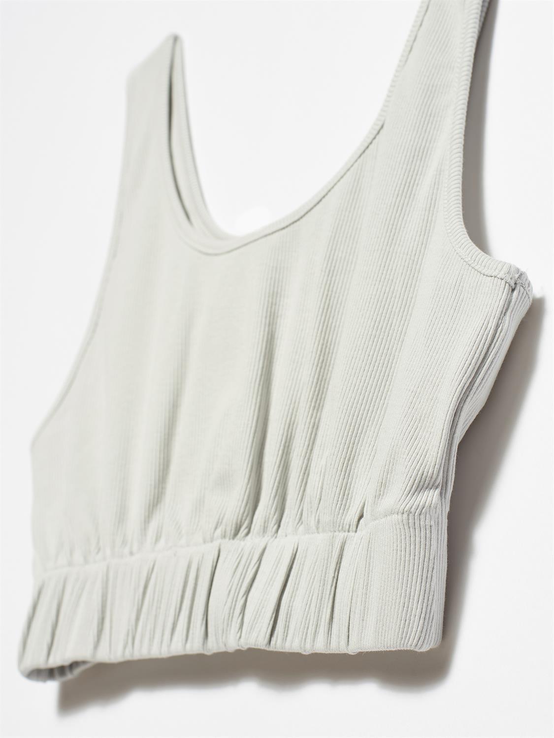 A stylish strappy top made from 96% cotton and 4% elastane, featuring thin straps and a comfortable fit.