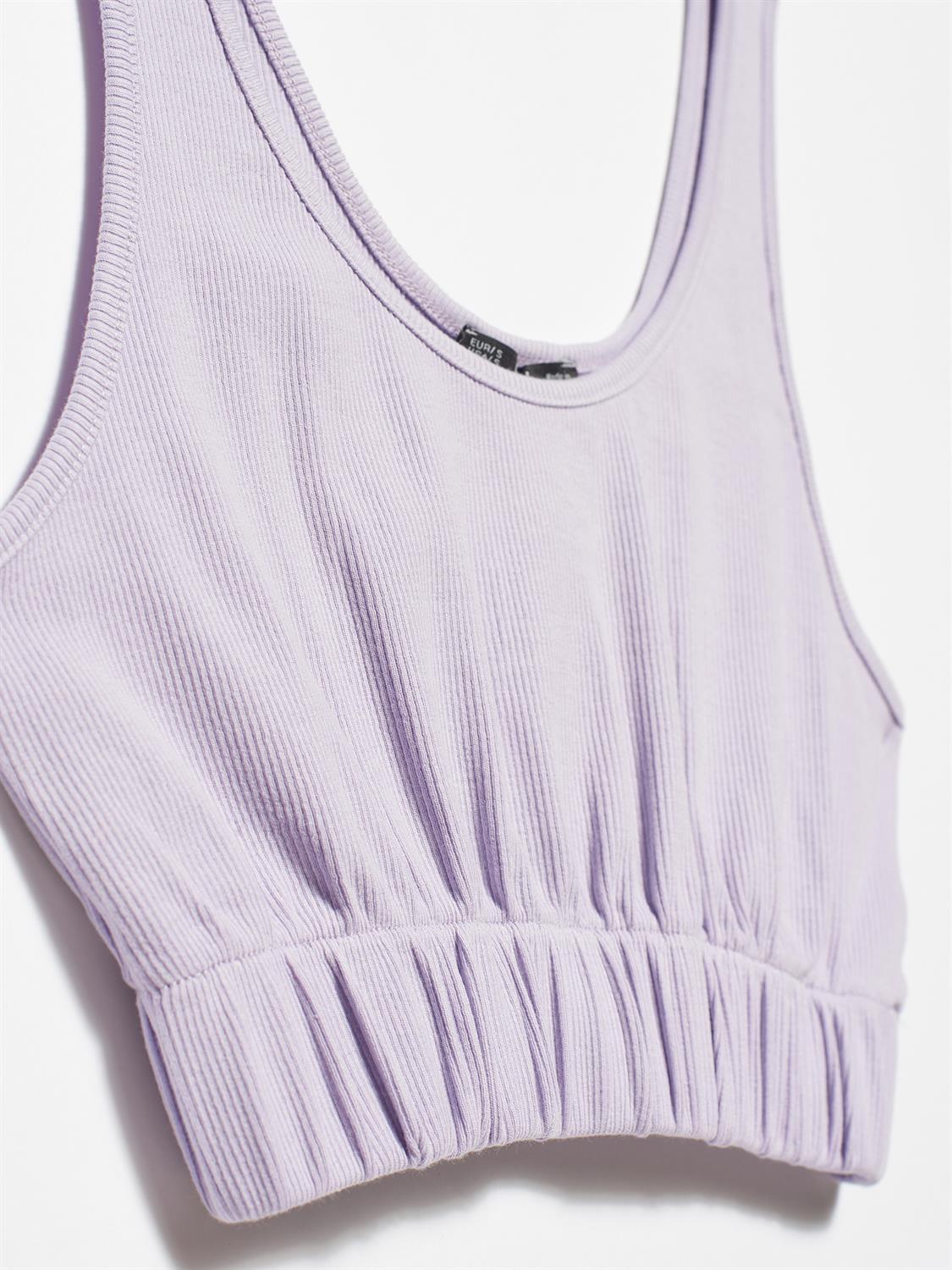 A stylish strappy top made from 96% cotton and 4% elastane, featuring thin straps and a comfortable fit.