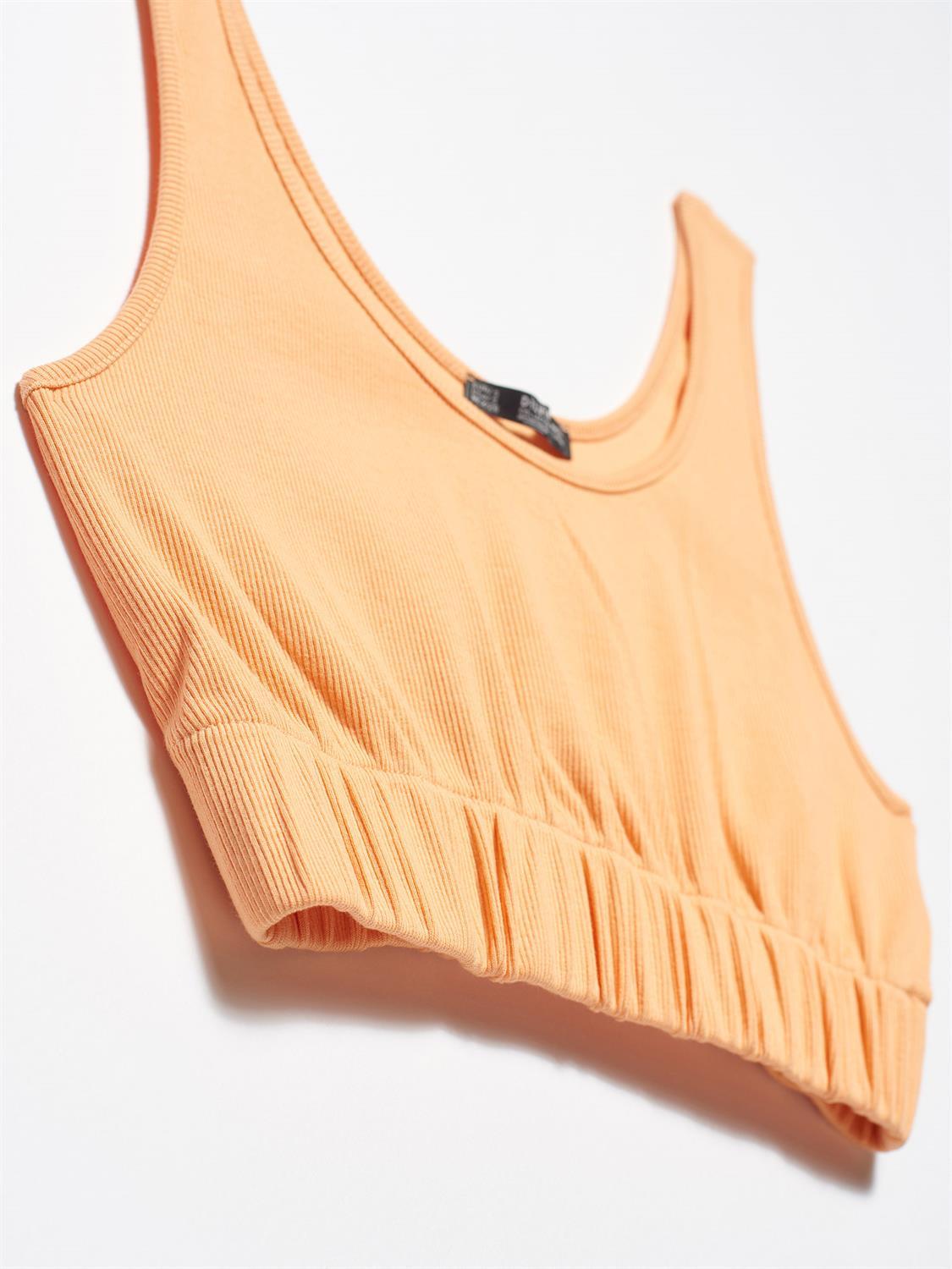 A stylish strappy top made from 96% cotton and 4% elastane, featuring thin straps and a comfortable fit.