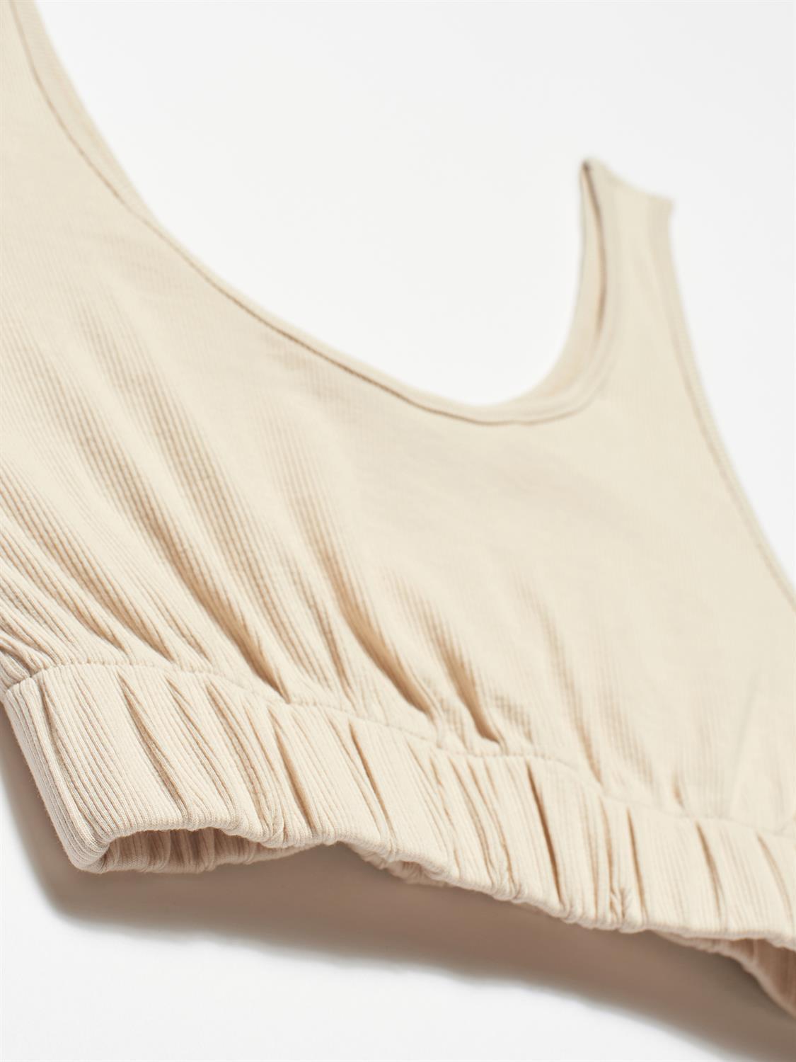 A stylish strappy top made from 96% cotton and 4% elastane, featuring thin straps and a comfortable fit.