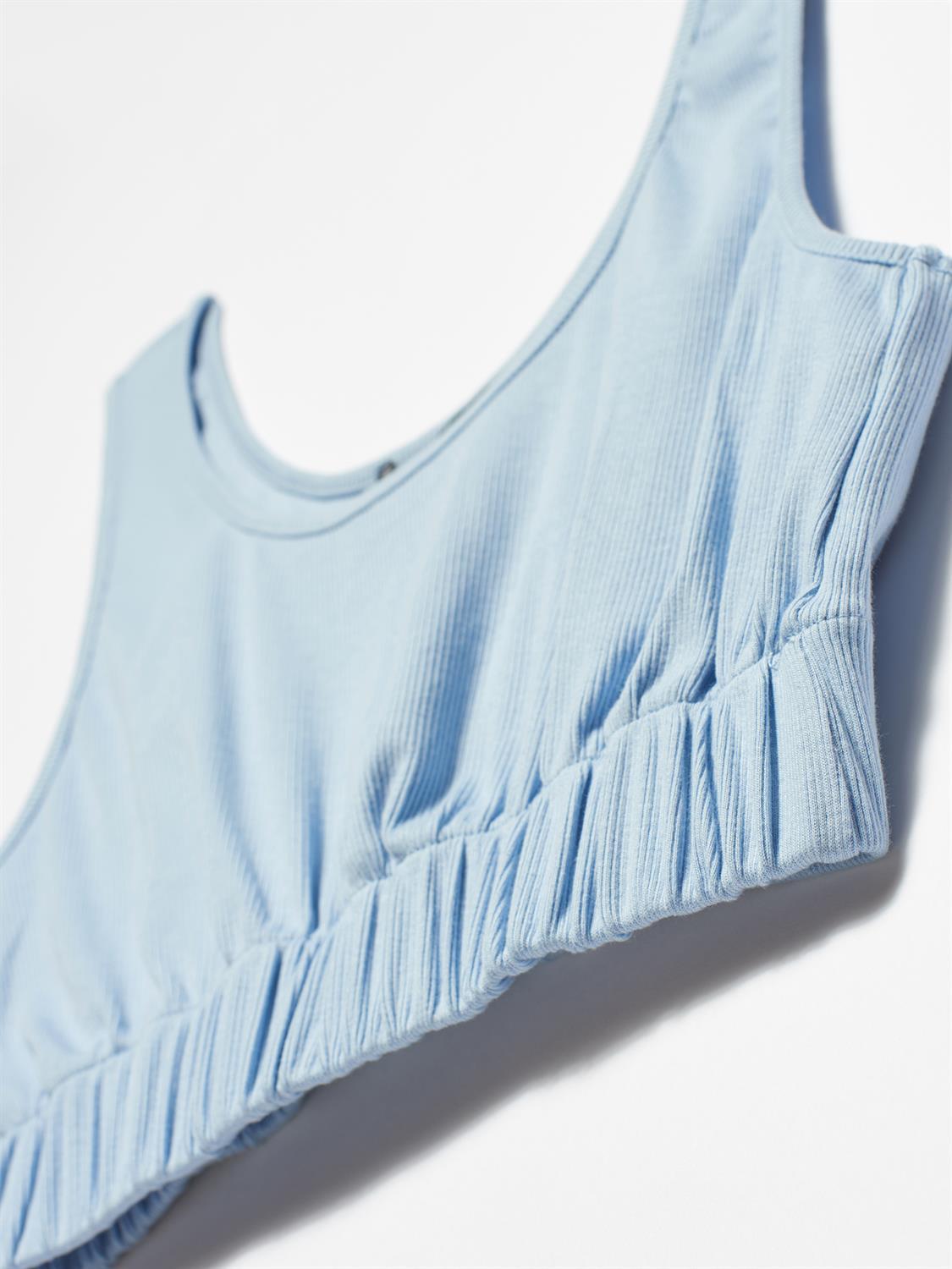 A stylish strappy top made from 96% cotton and 4% elastane, featuring thin straps and a comfortable fit.