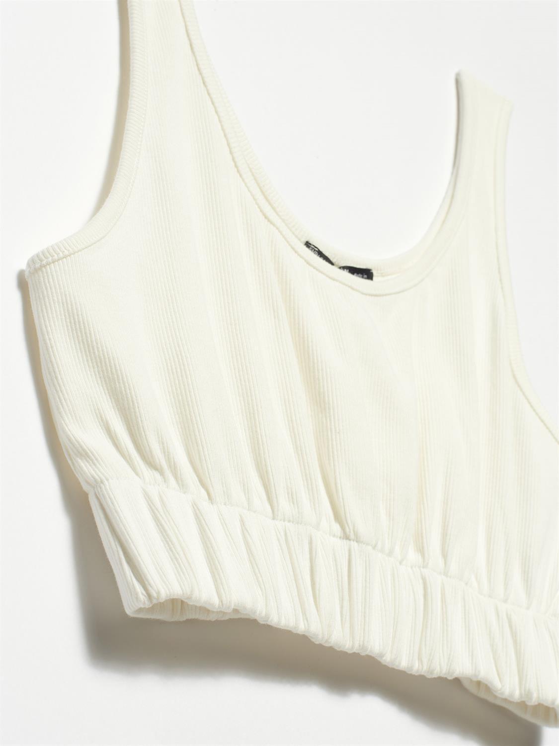 A stylish strappy top made from 96% cotton and 4% elastane, featuring thin straps and a comfortable fit.