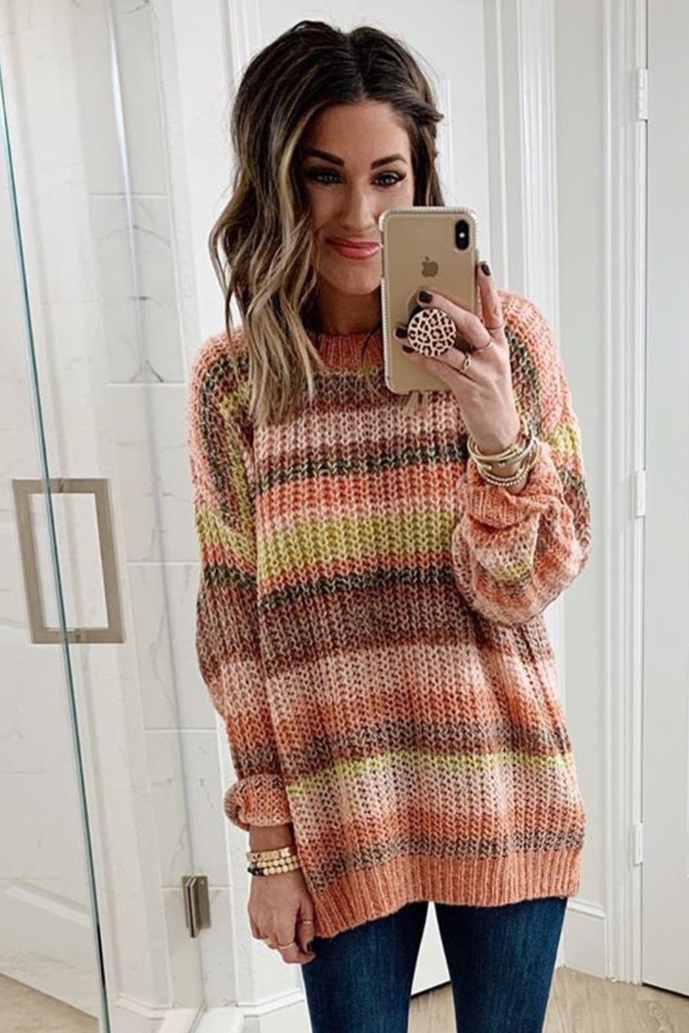 A vibrant Stripe Color Block Chunky Sweater featuring a mix of cream, pink, orange, yellow, and red stripes, showcasing a relaxed fit and long sleeves.