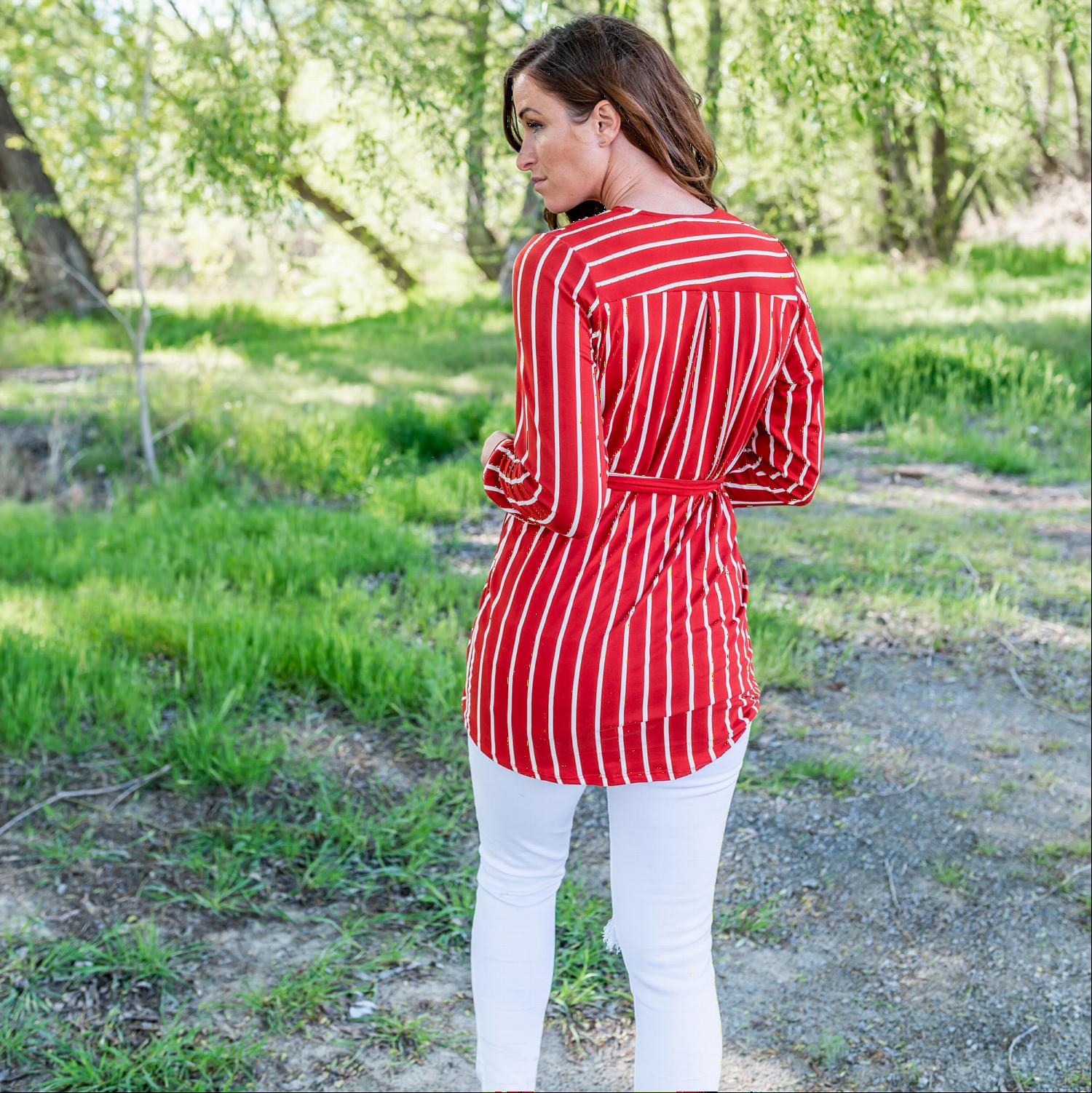 A stylish striped front tie dress featuring a modest v-neck and long sleeves, perfect for versatile wear.