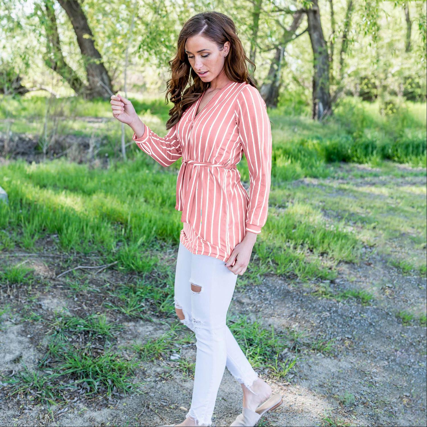 A stylish striped front tie dress featuring a modest v-neck and long sleeves, perfect for versatile wear.