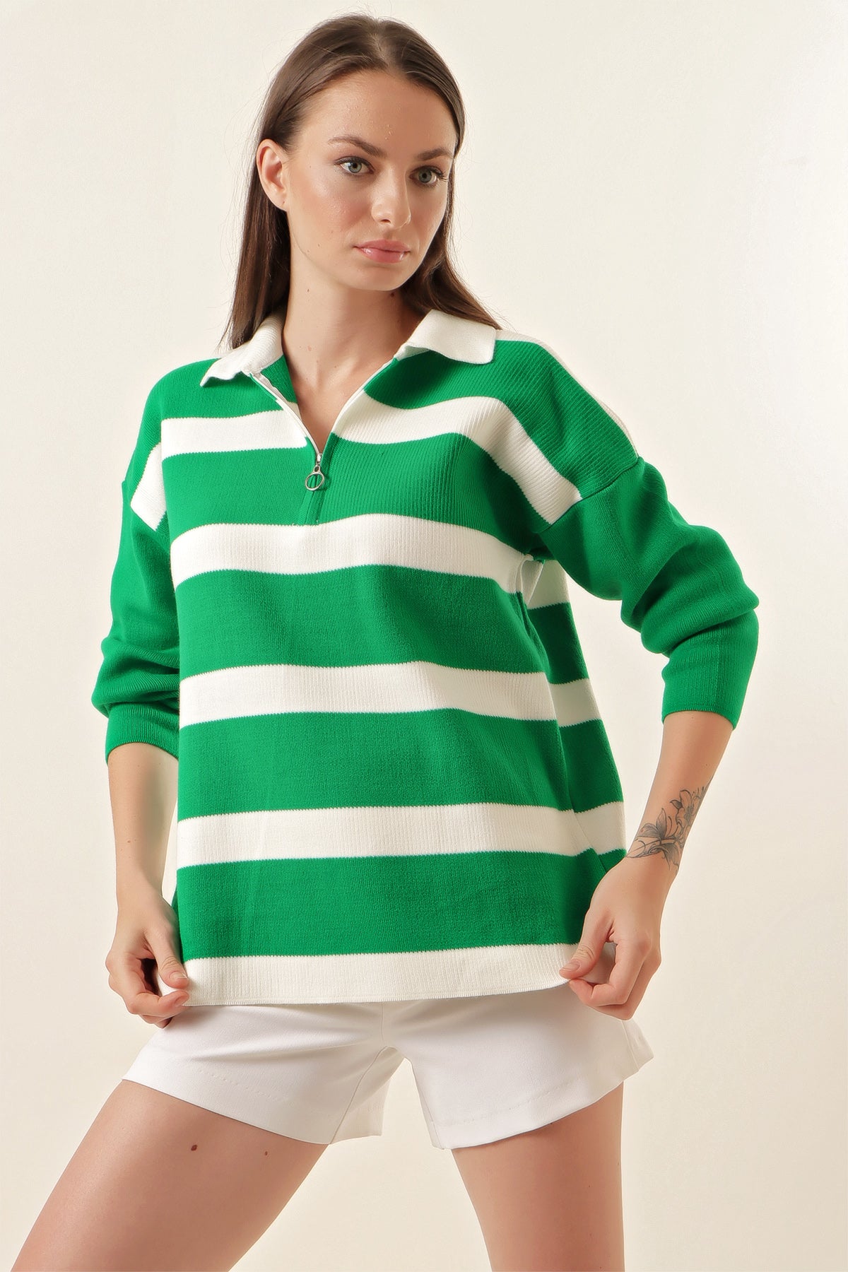 A cozy striped green sweater featuring a classic design with a comfortable neckline, perfect for seasonal wear.