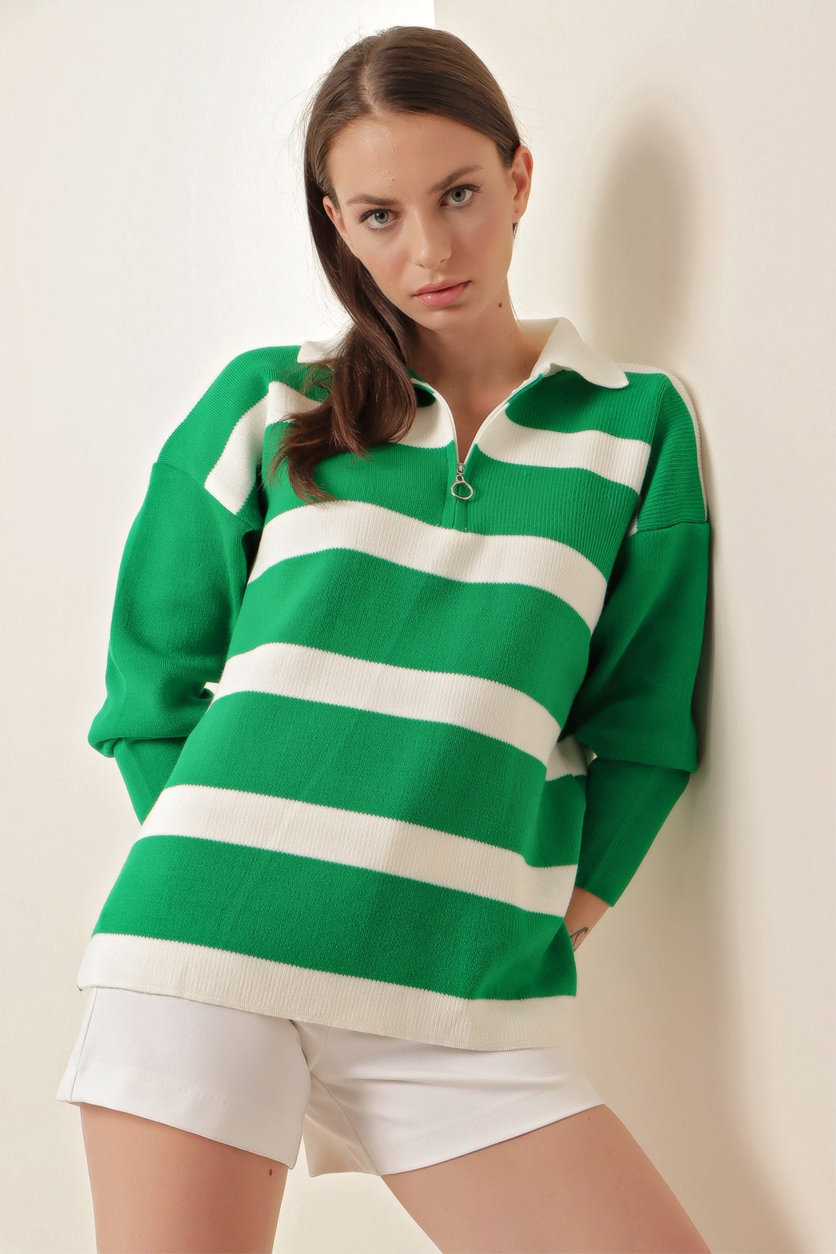 A cozy striped green sweater featuring a classic design with a comfortable neckline, perfect for seasonal wear.