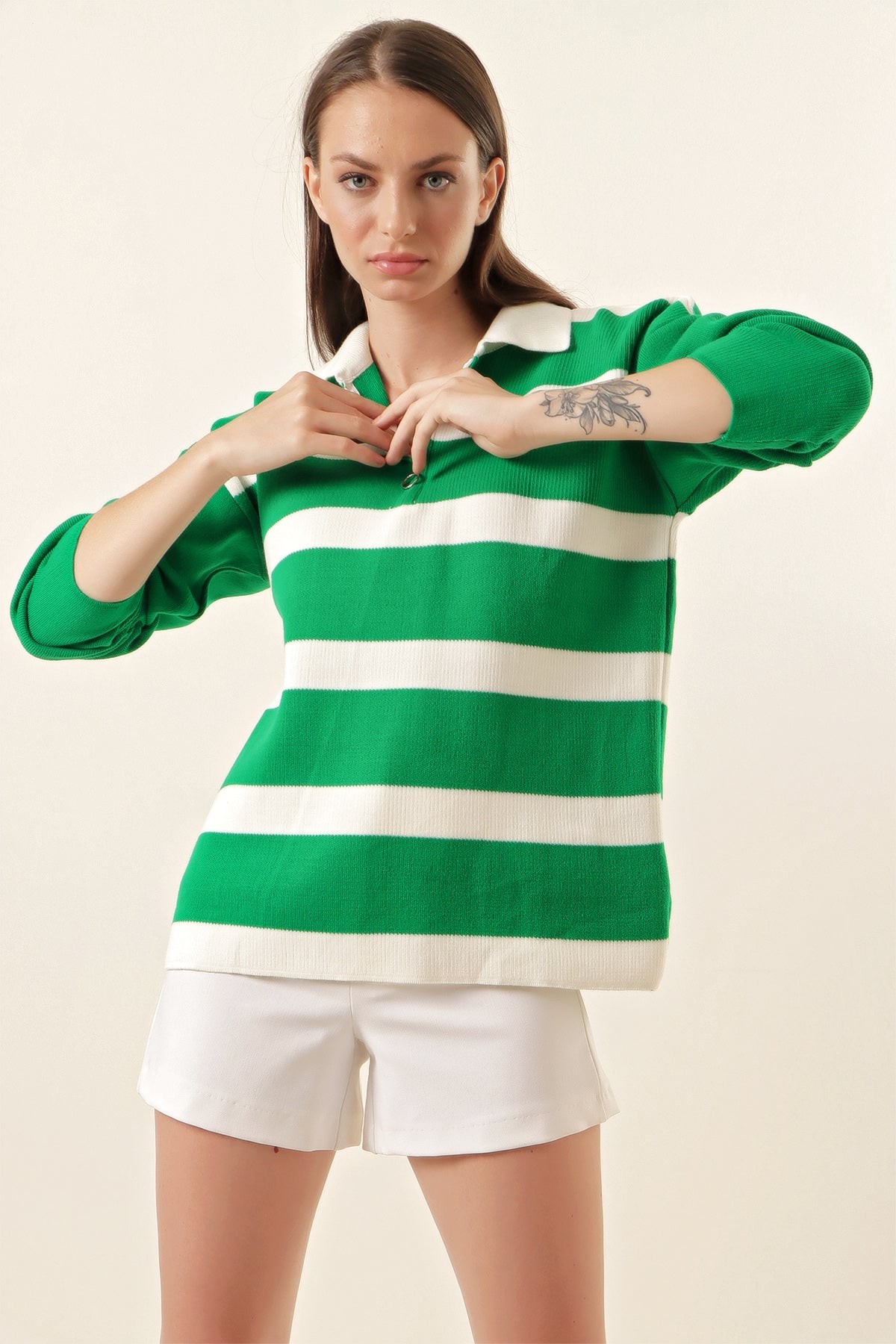 A cozy striped green sweater featuring a classic design with a comfortable neckline, perfect for seasonal wear.