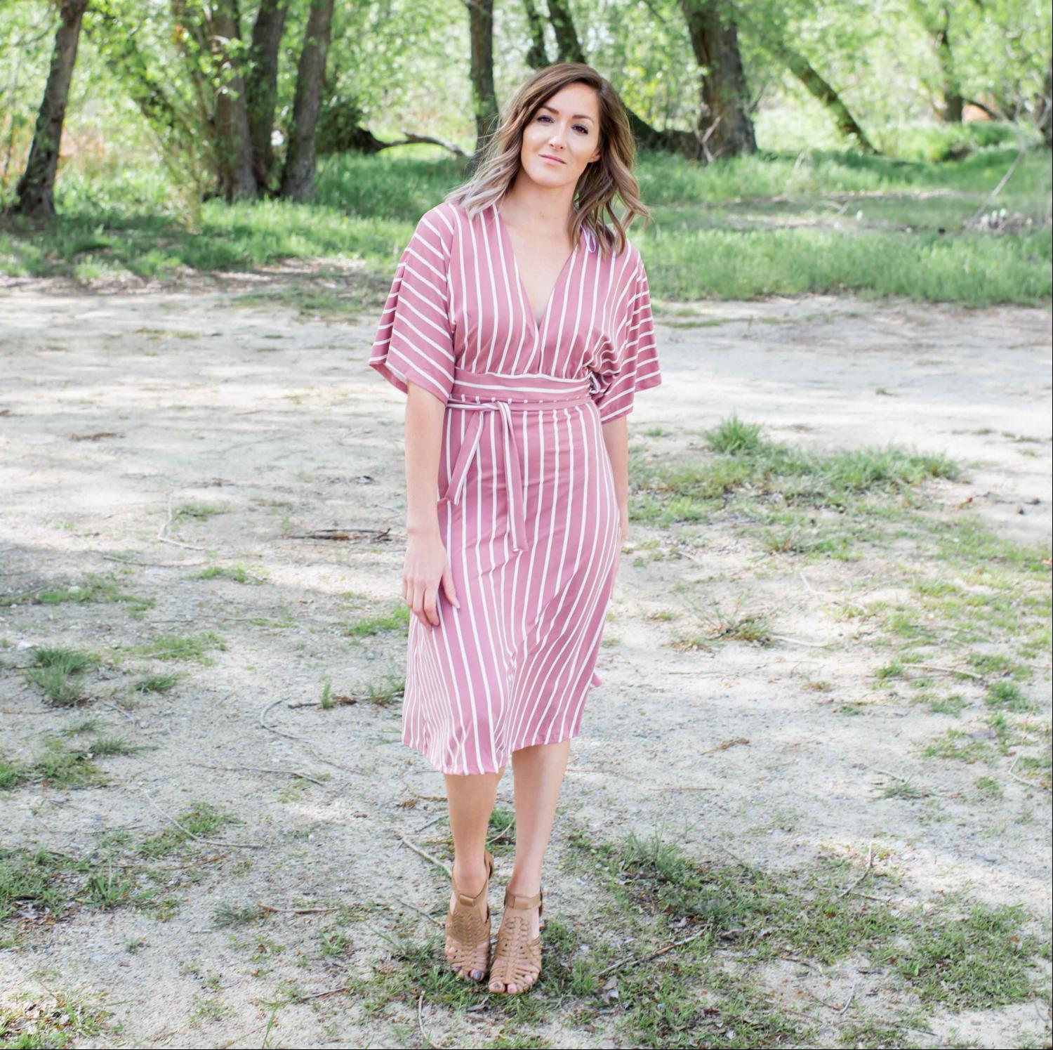 A stylish striped vee neck dress featuring a plunging neckline, self-tie waist, and soft swingy sleeves, perfect for summer outings.