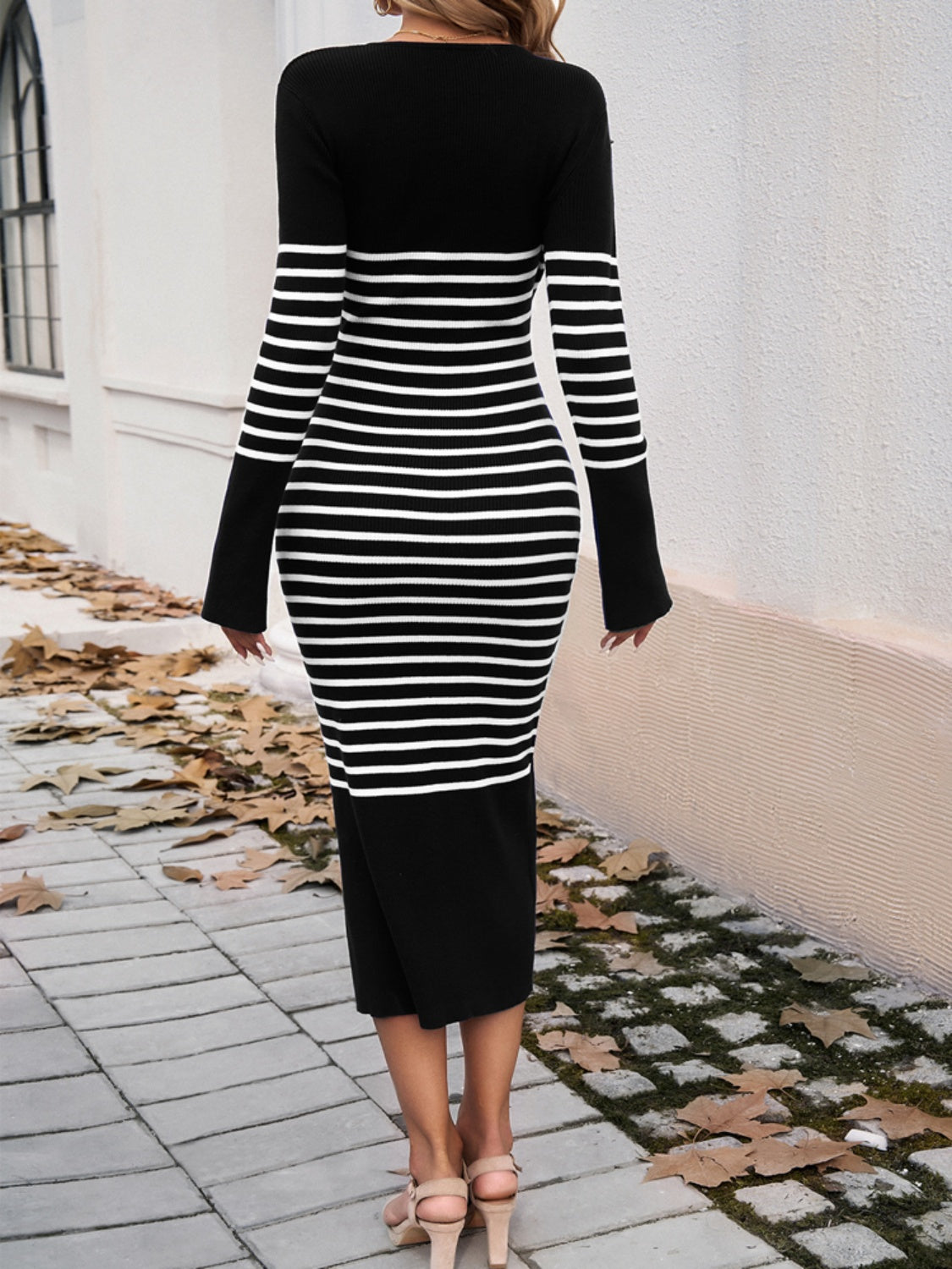 A stylish striped V-neck long sleeve sweater dress displayed on a mannequin, showcasing its elegant design and comfortable fit.