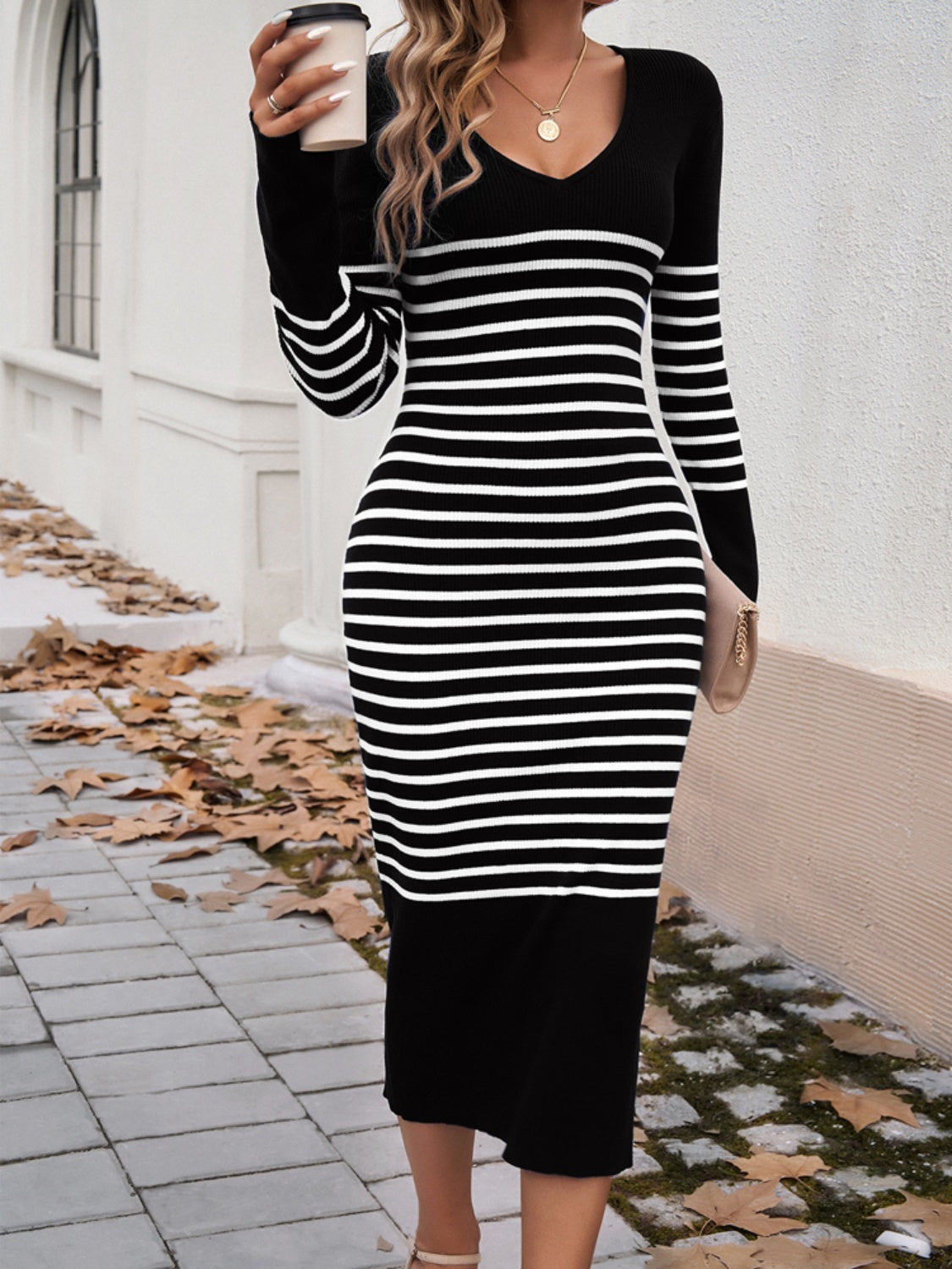 A stylish striped V-neck long sleeve sweater dress displayed on a mannequin, showcasing its elegant design and comfortable fit.