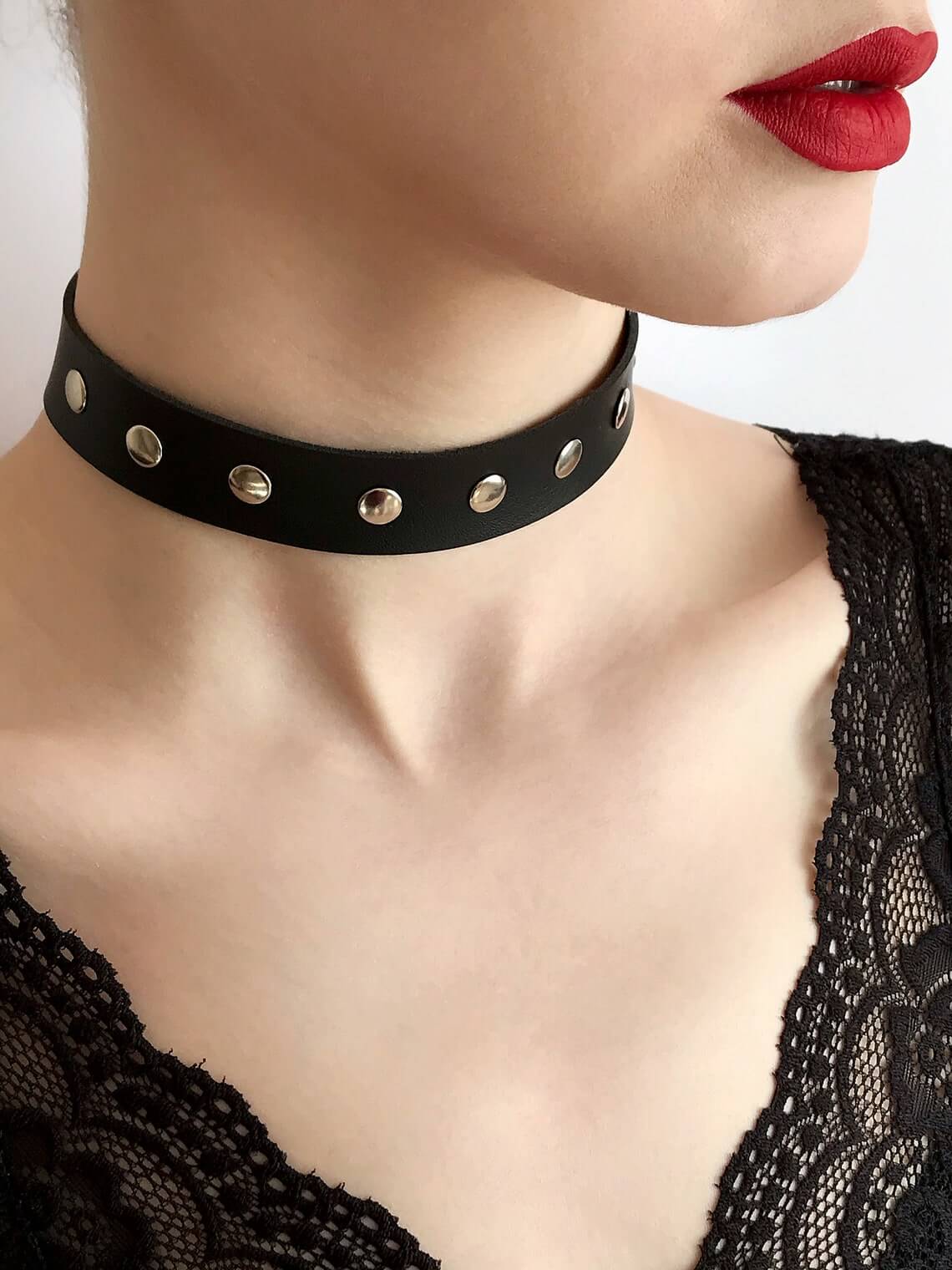 A stylish studded leather choker featuring shiny spikes, perfect for enhancing any outfit.