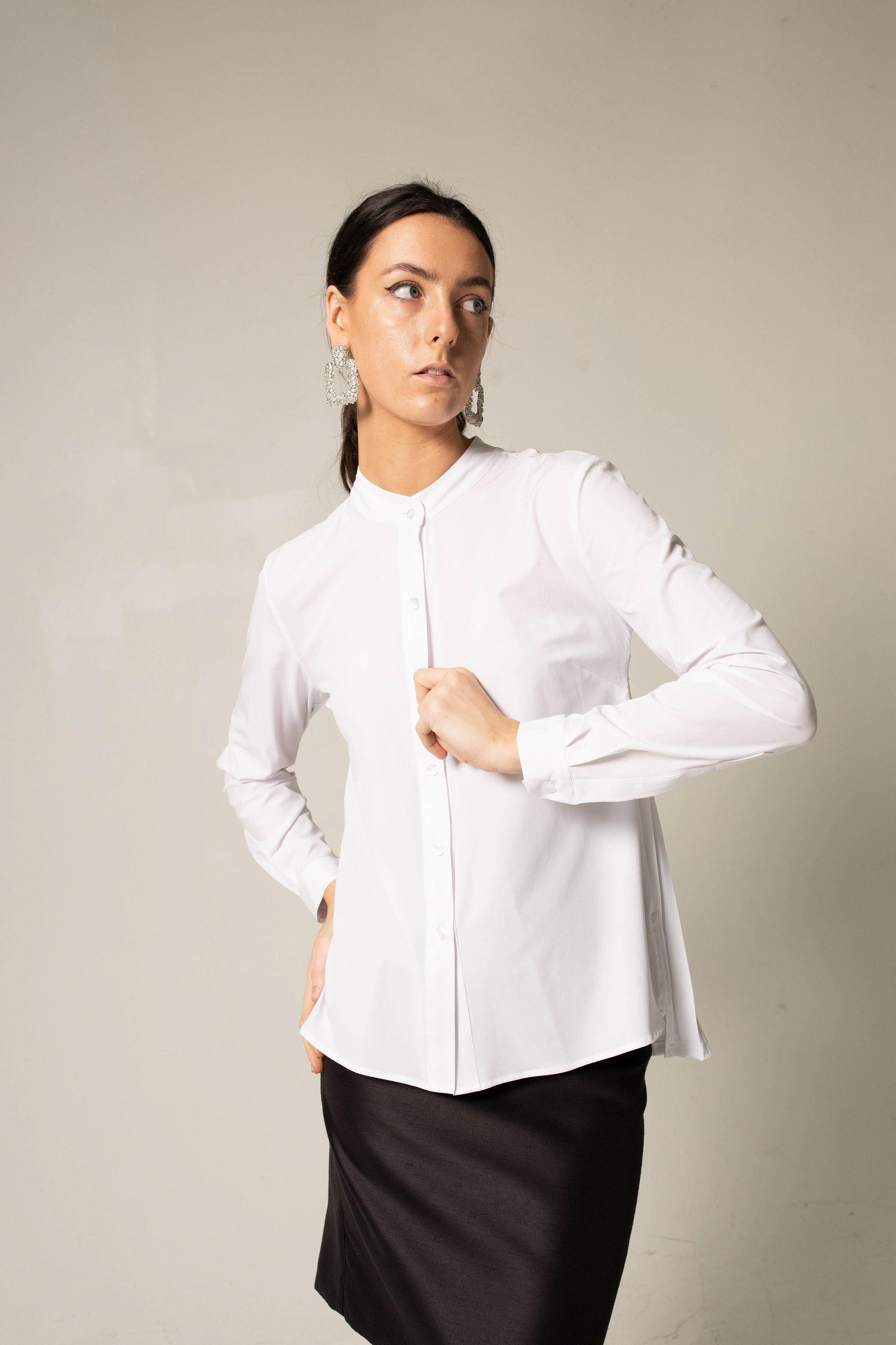 Stylish white pleated blouse with elegant design, perfect for all seasons.