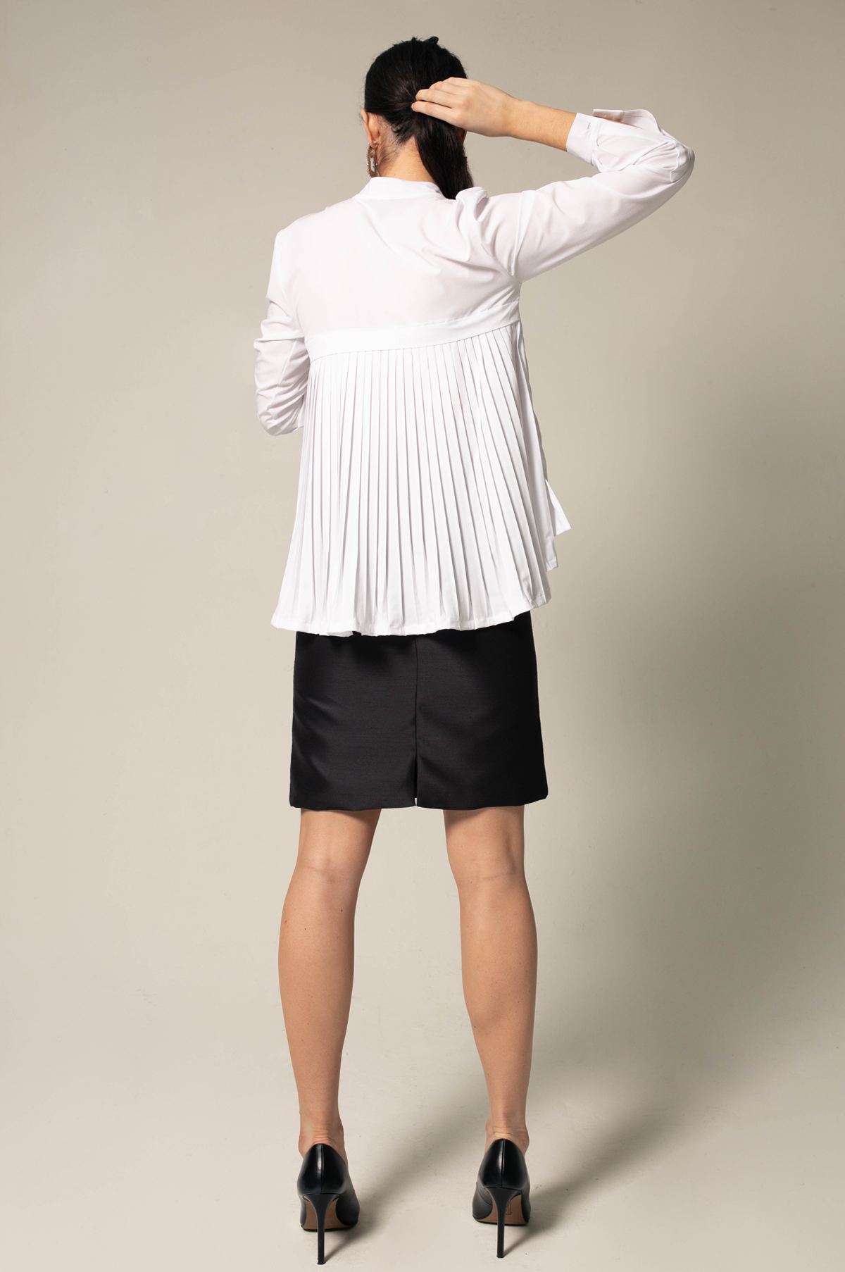 Stylish white pleated blouse with elegant design, perfect for all seasons.