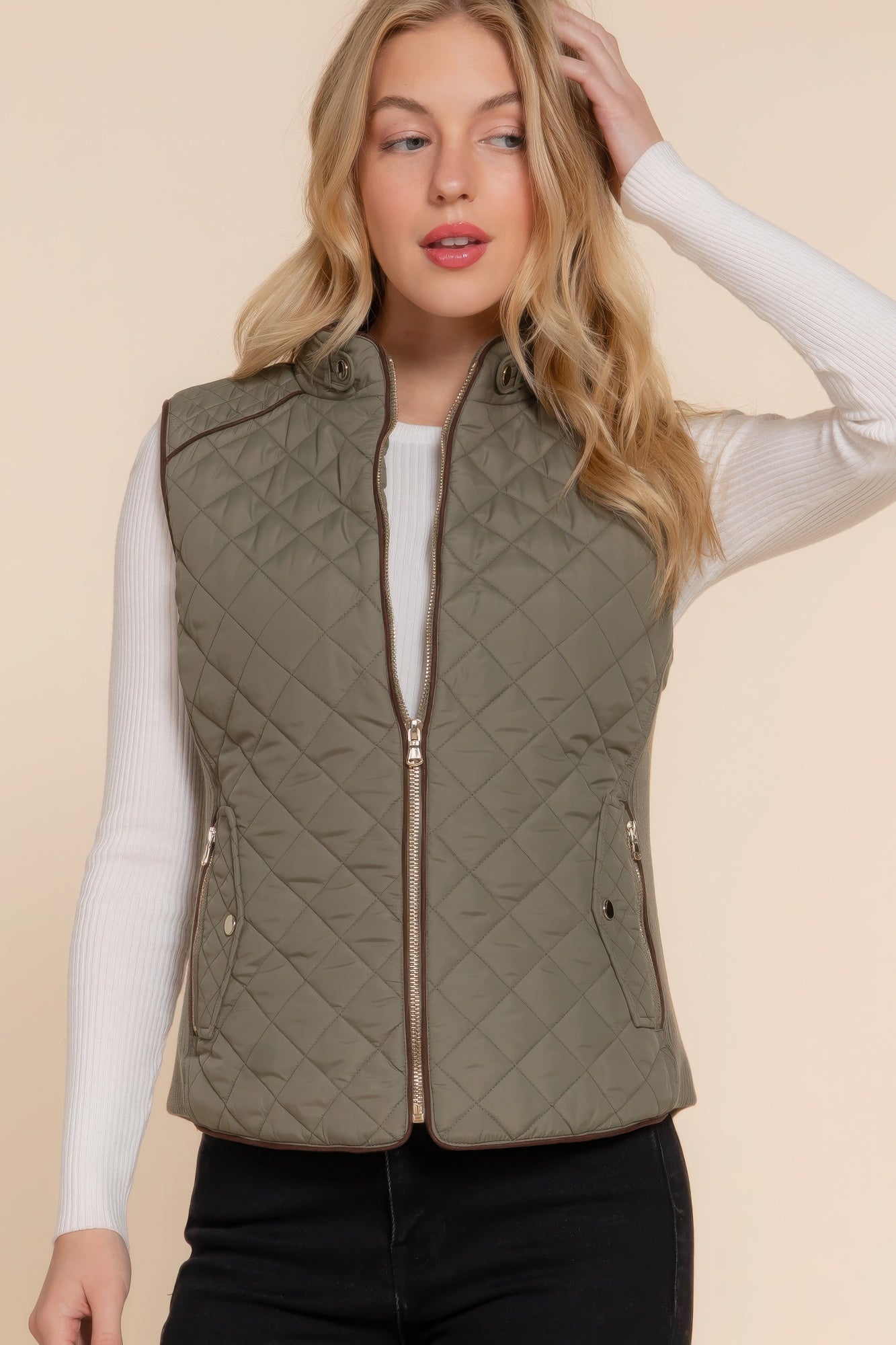 A stylish Suede Piping Quilted Padding Vest in Pale Taupe color, featuring suede piping details and front pockets, perfect for layering.