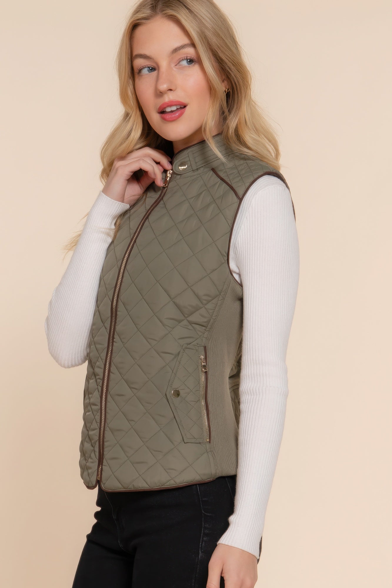 A stylish Suede Piping Quilted Padding Vest in Pale Taupe color, featuring suede piping details and front pockets, perfect for layering.