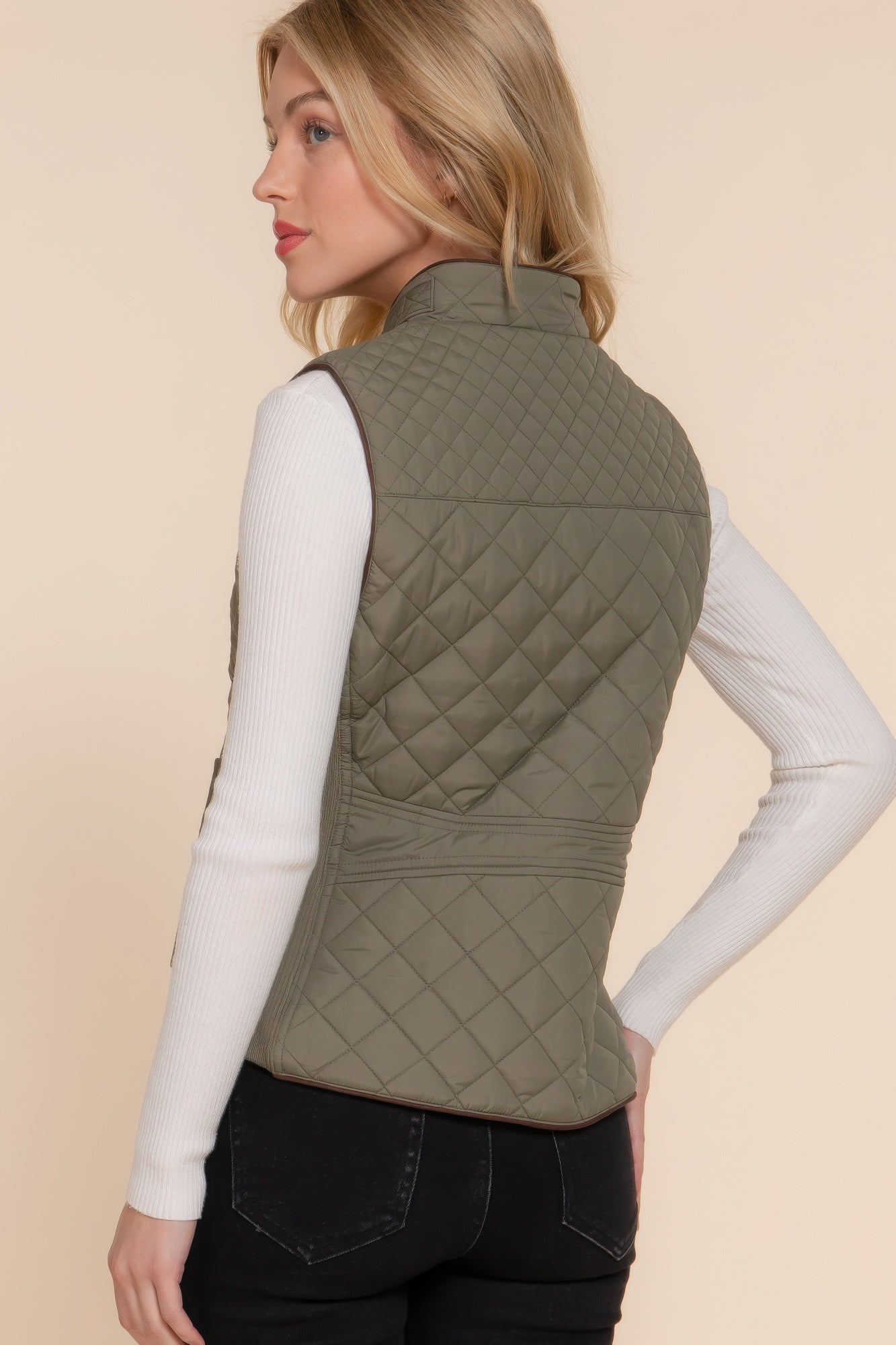 A stylish Suede Piping Quilted Padding Vest in Pale Taupe color, featuring suede piping details and front pockets, perfect for layering.