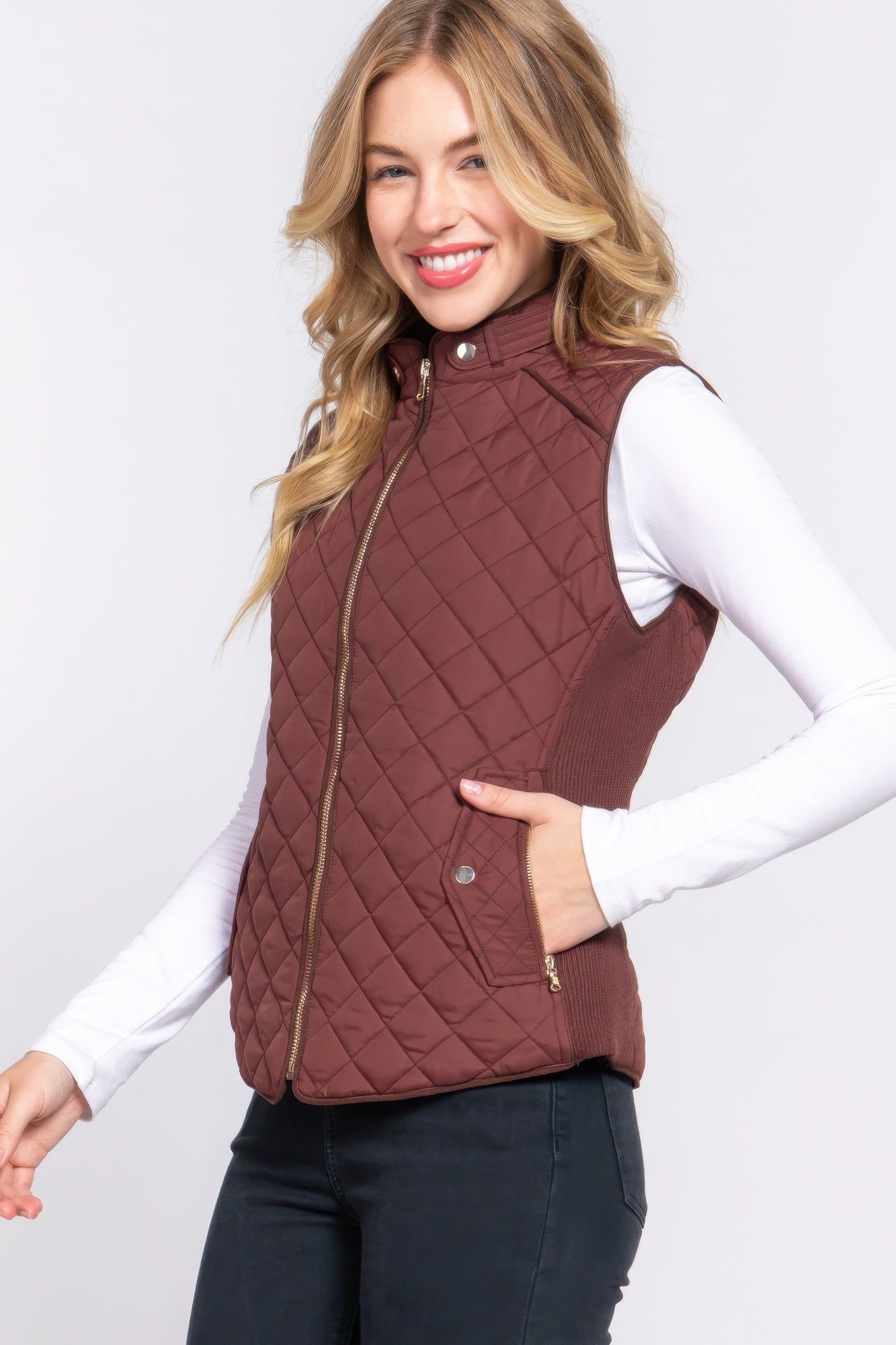 A stylish Suede Piping Quilted Padding Vest in Pale Taupe color, featuring suede piping details and front pockets, perfect for layering.