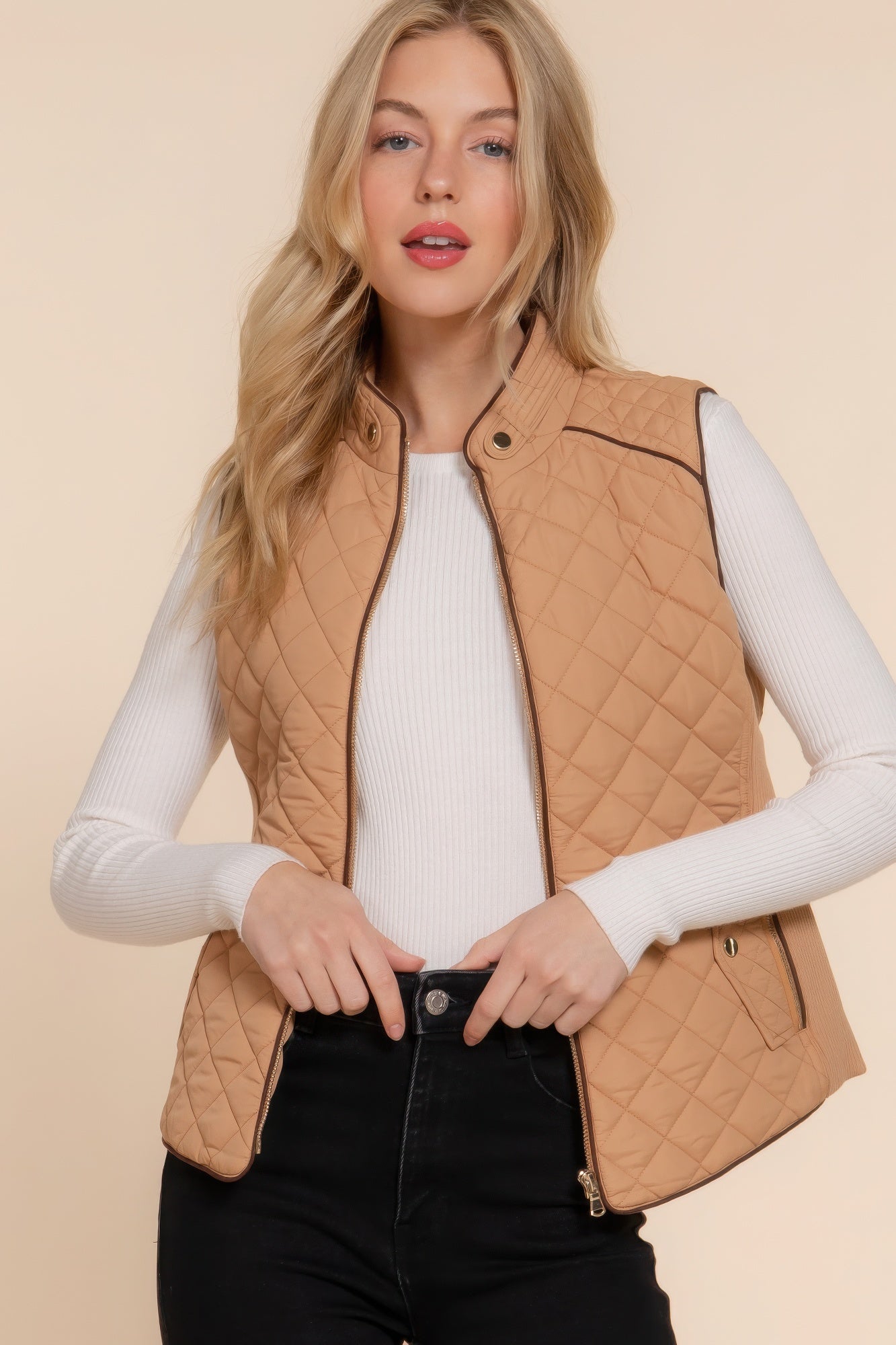 A stylish Suede Piping Quilted Padding Vest in Pale Taupe color, featuring suede piping details and front pockets, perfect for layering.