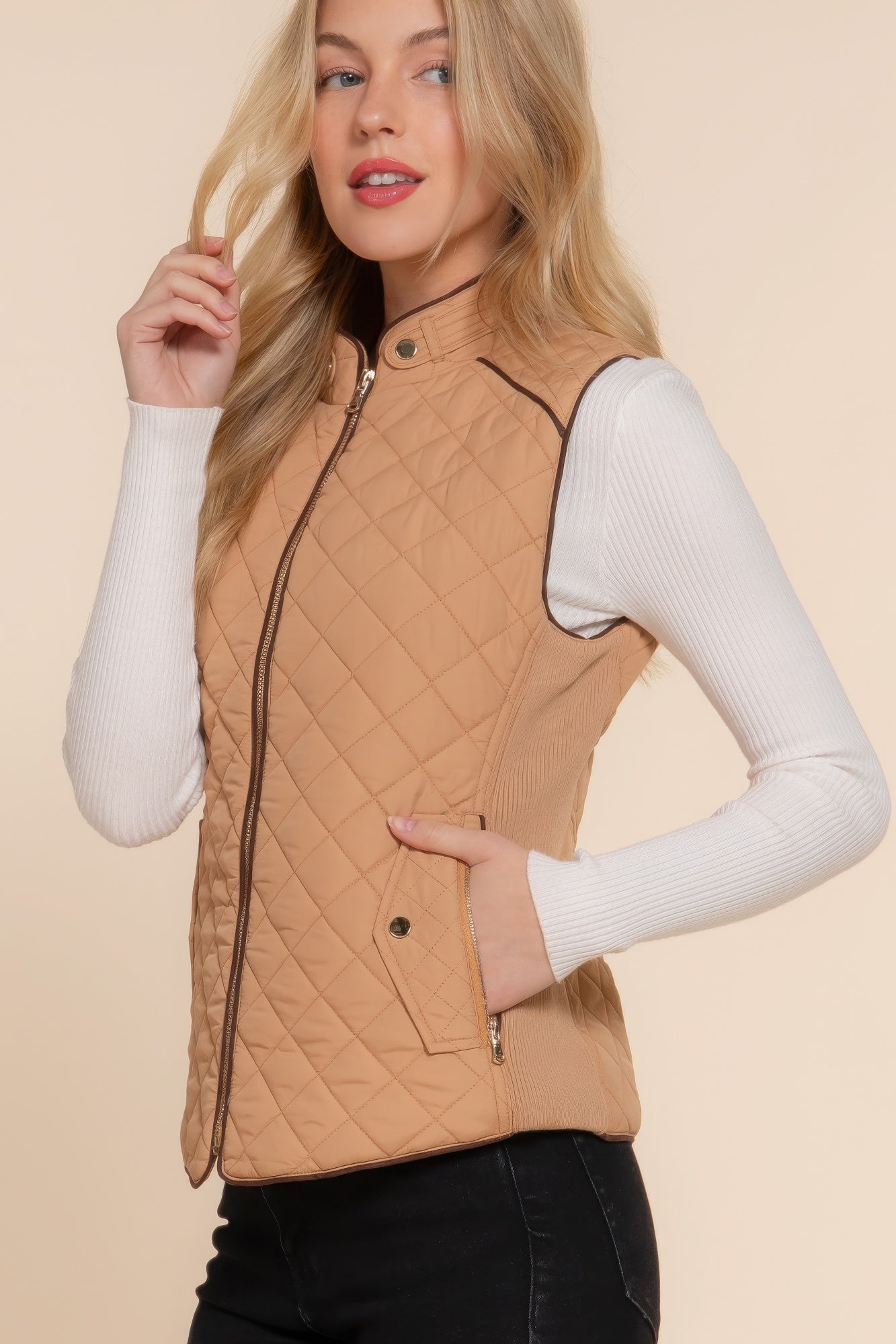 A stylish Suede Piping Quilted Padding Vest in Pale Taupe color, featuring suede piping details and front pockets, perfect for layering.