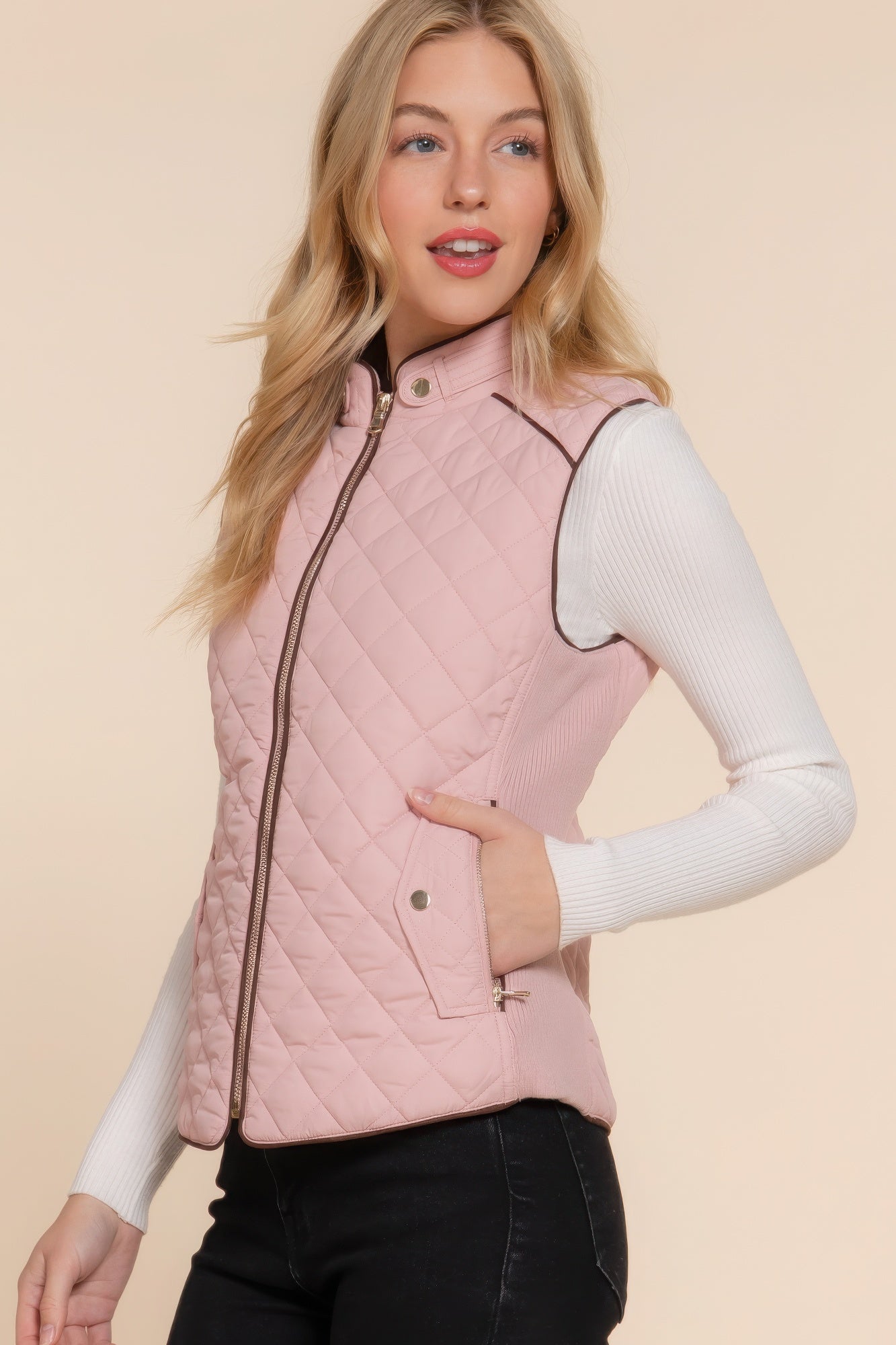 A stylish Suede Piping Quilted Padding Vest in Pale Taupe color, featuring suede piping details and front pockets, perfect for layering.