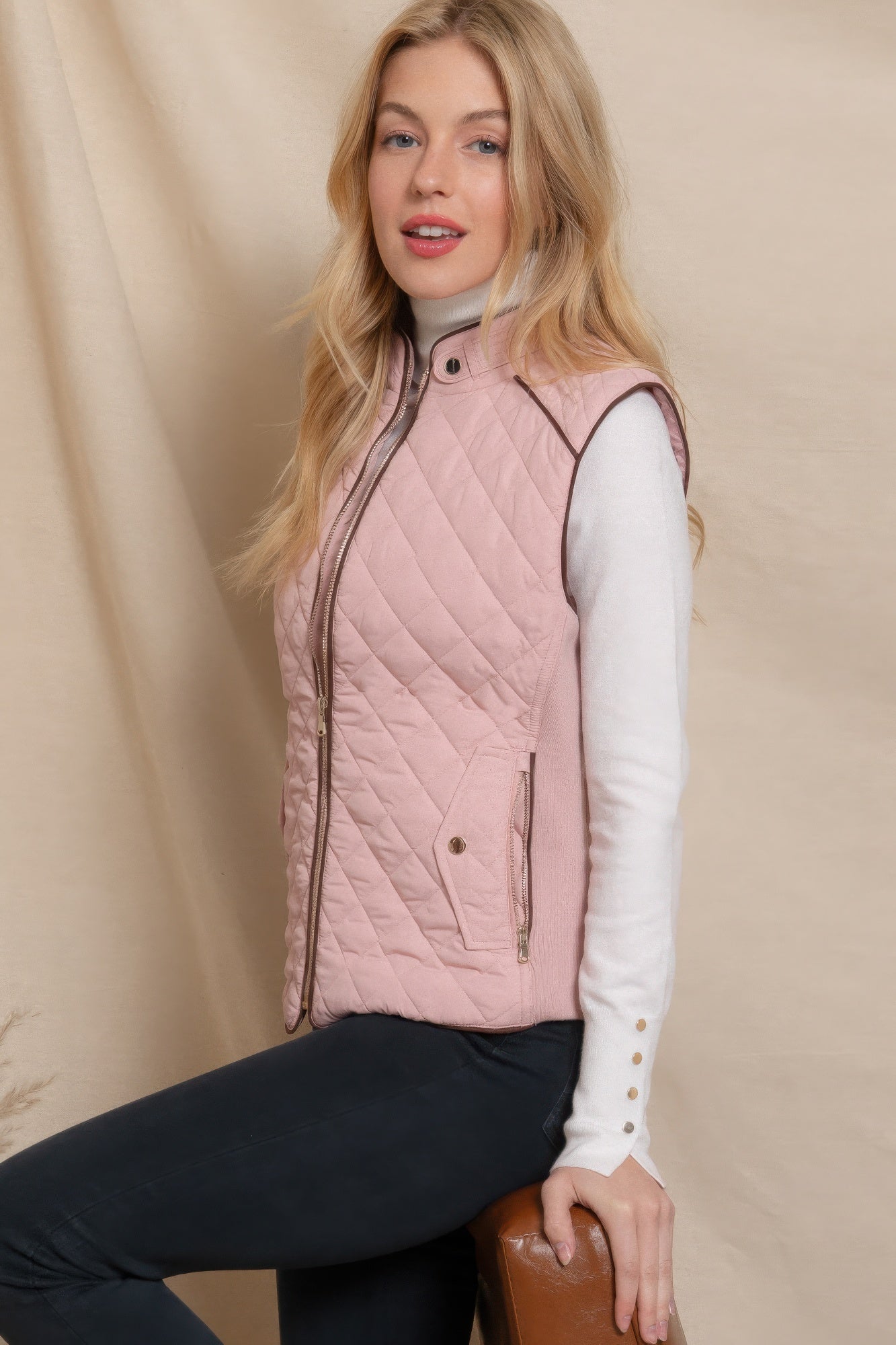 A stylish Suede Piping Quilted Padding Vest in Pale Taupe color, featuring suede piping details and front pockets, perfect for layering.