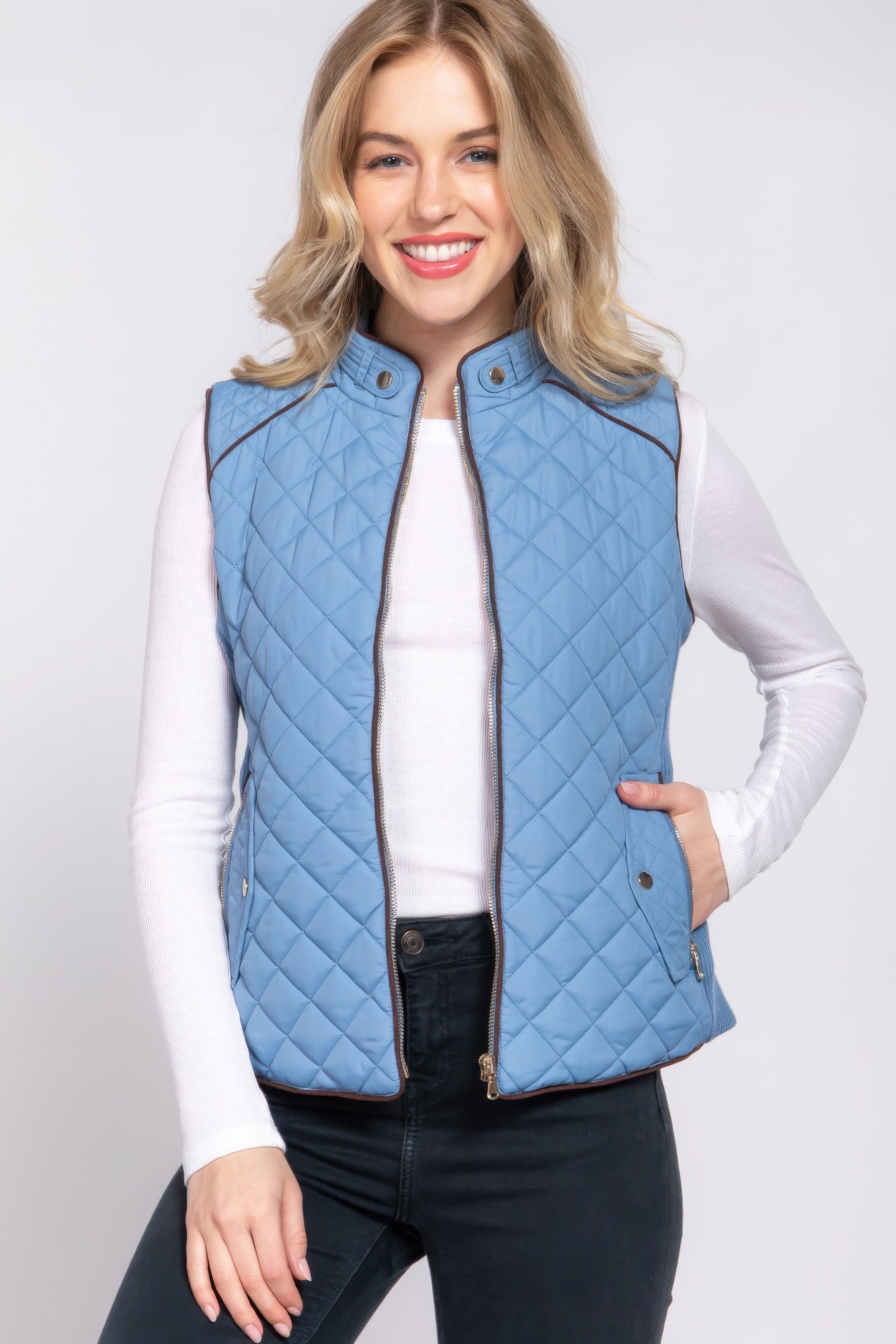 A stylish Suede Piping Quilted Padding Vest in Pale Taupe color, featuring suede piping details and front pockets, perfect for layering.