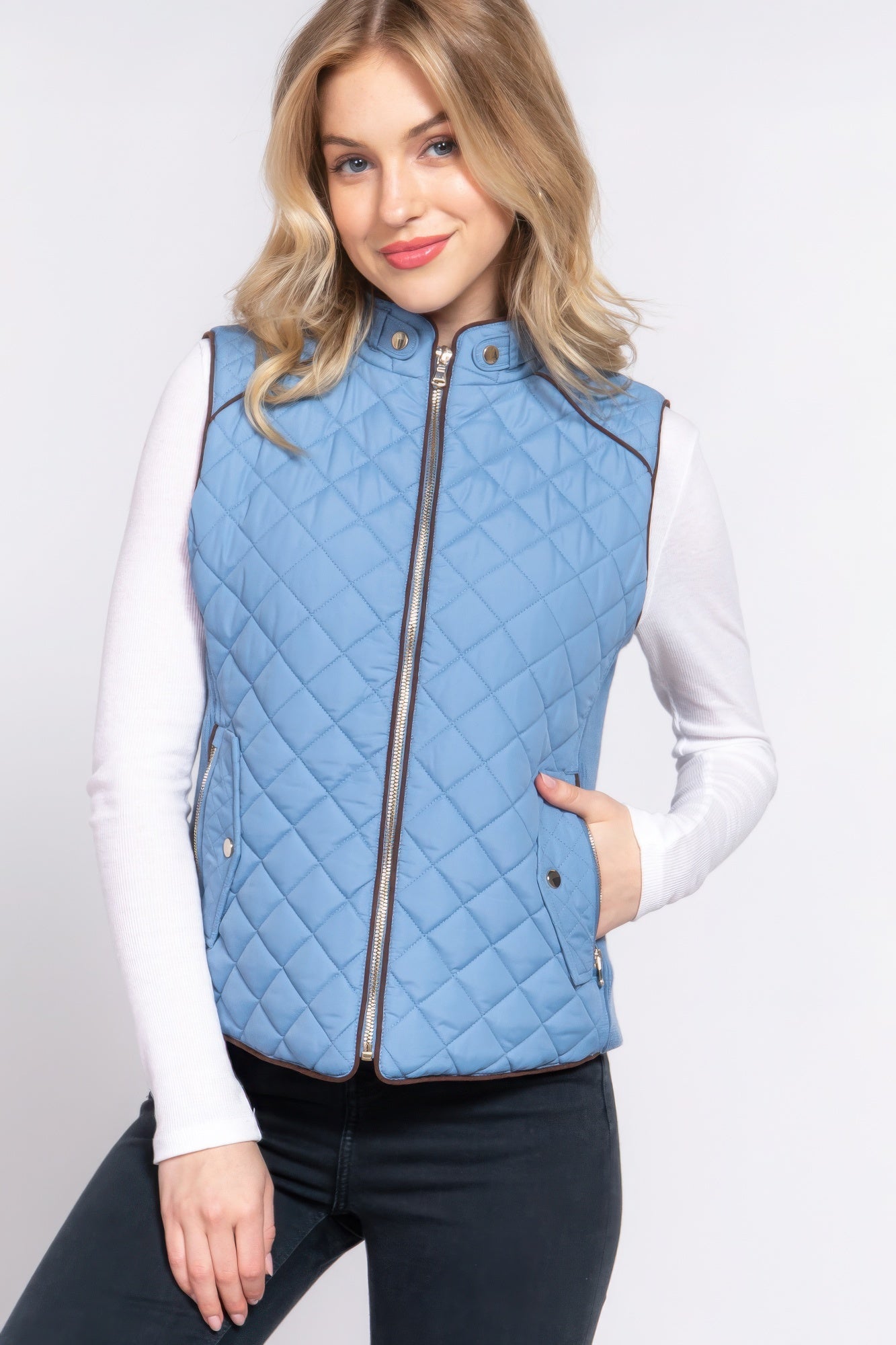 A stylish Suede Piping Quilted Padding Vest in Pale Taupe color, featuring suede piping details and front pockets, perfect for layering.