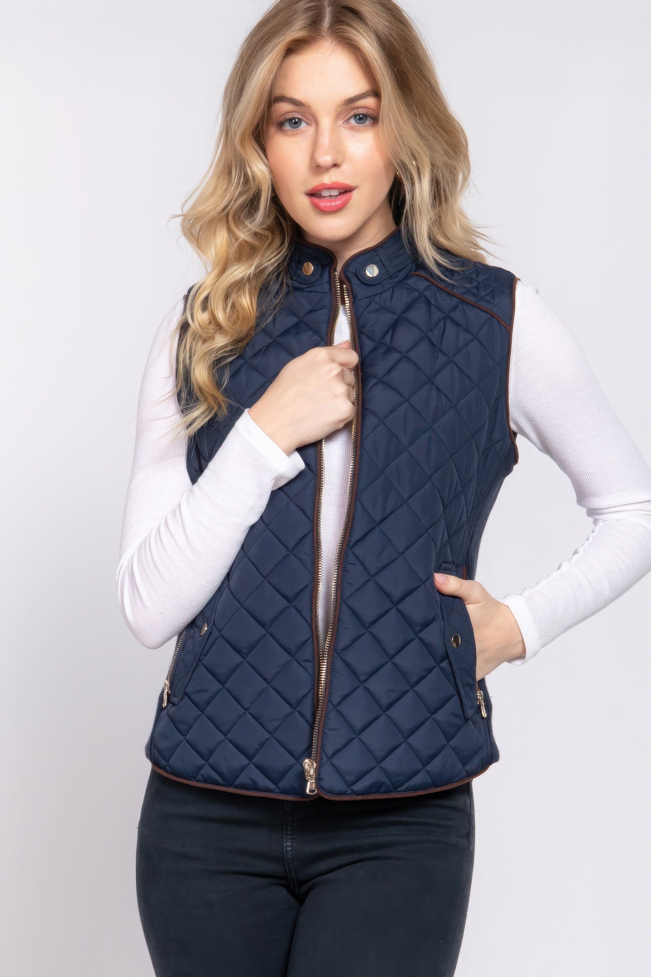 A stylish Suede Piping Quilted Padding Vest in Pale Taupe color, featuring suede piping details and front pockets, perfect for layering.