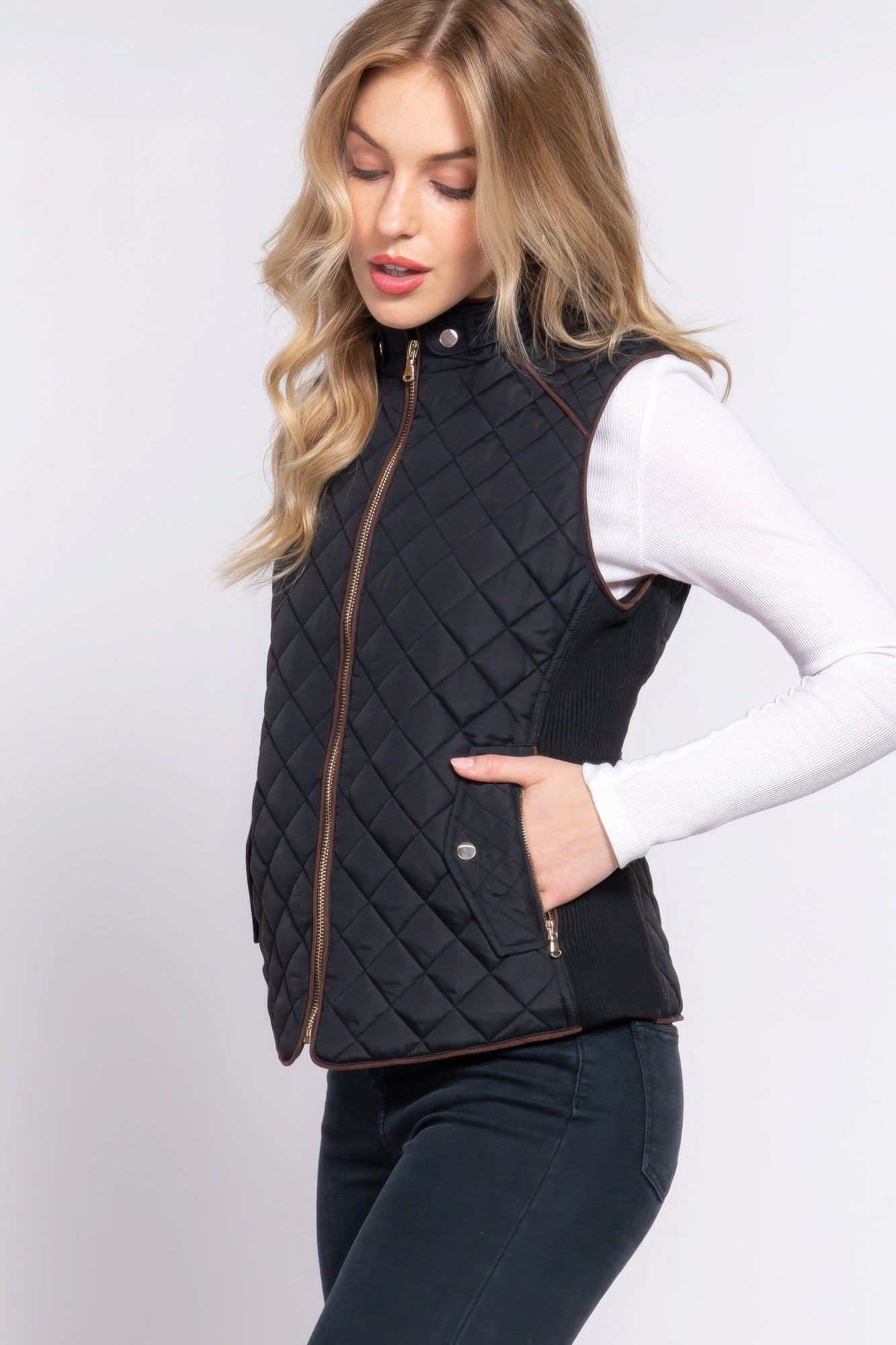 A stylish Suede Piping Quilted Padding Vest in Pale Taupe color, featuring suede piping details and front pockets, perfect for layering.