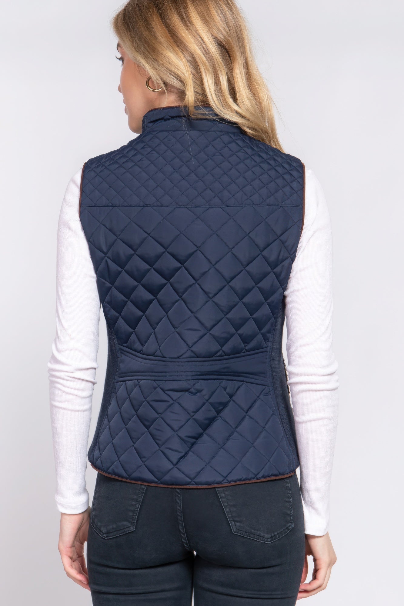 A stylish Suede Piping Quilted Padding Vest in Pale Taupe color, featuring suede piping details and front pockets, perfect for layering.