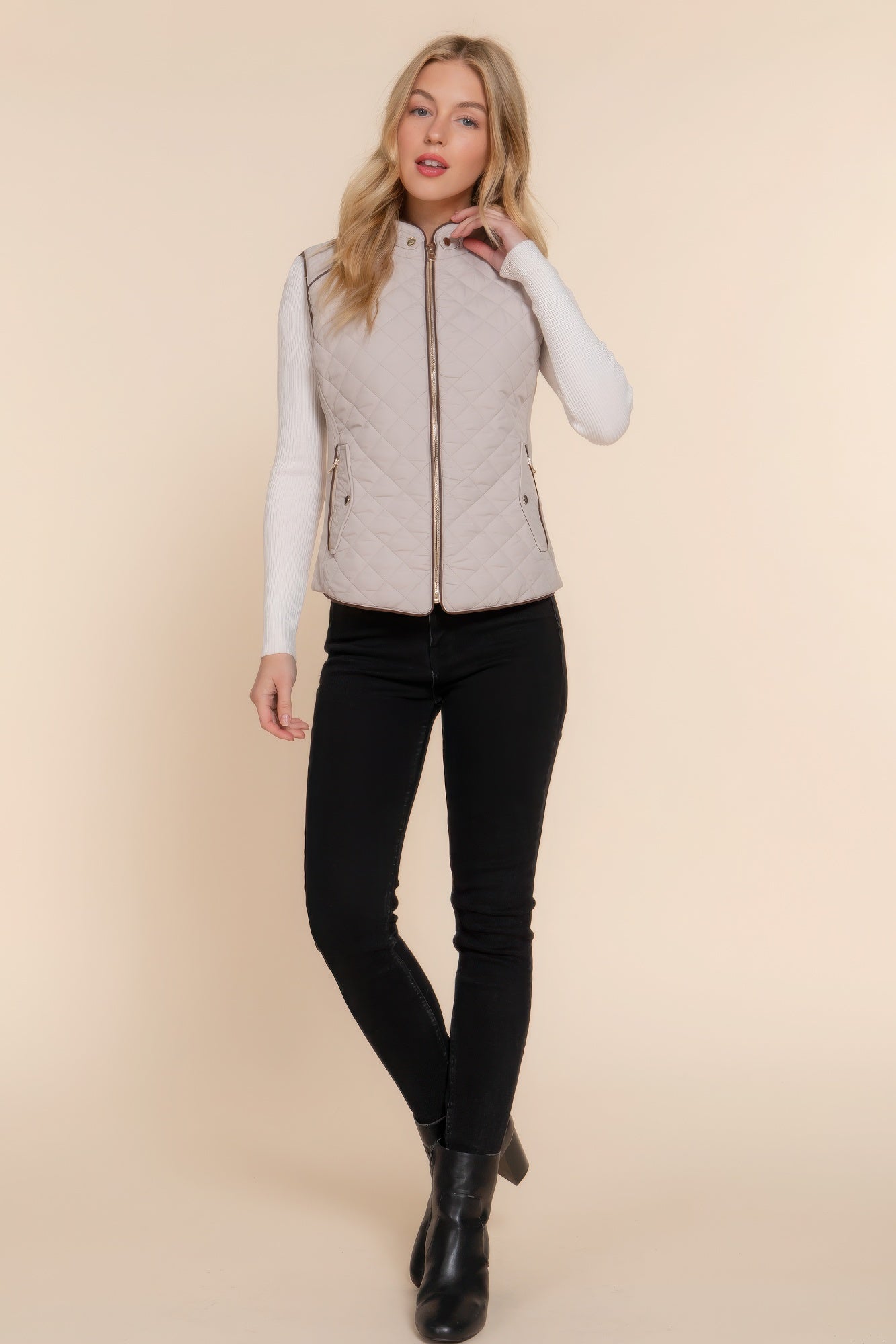 A stylish Suede Piping Quilted Padding Vest in Pale Taupe color, featuring suede piping details and front pockets, perfect for layering.