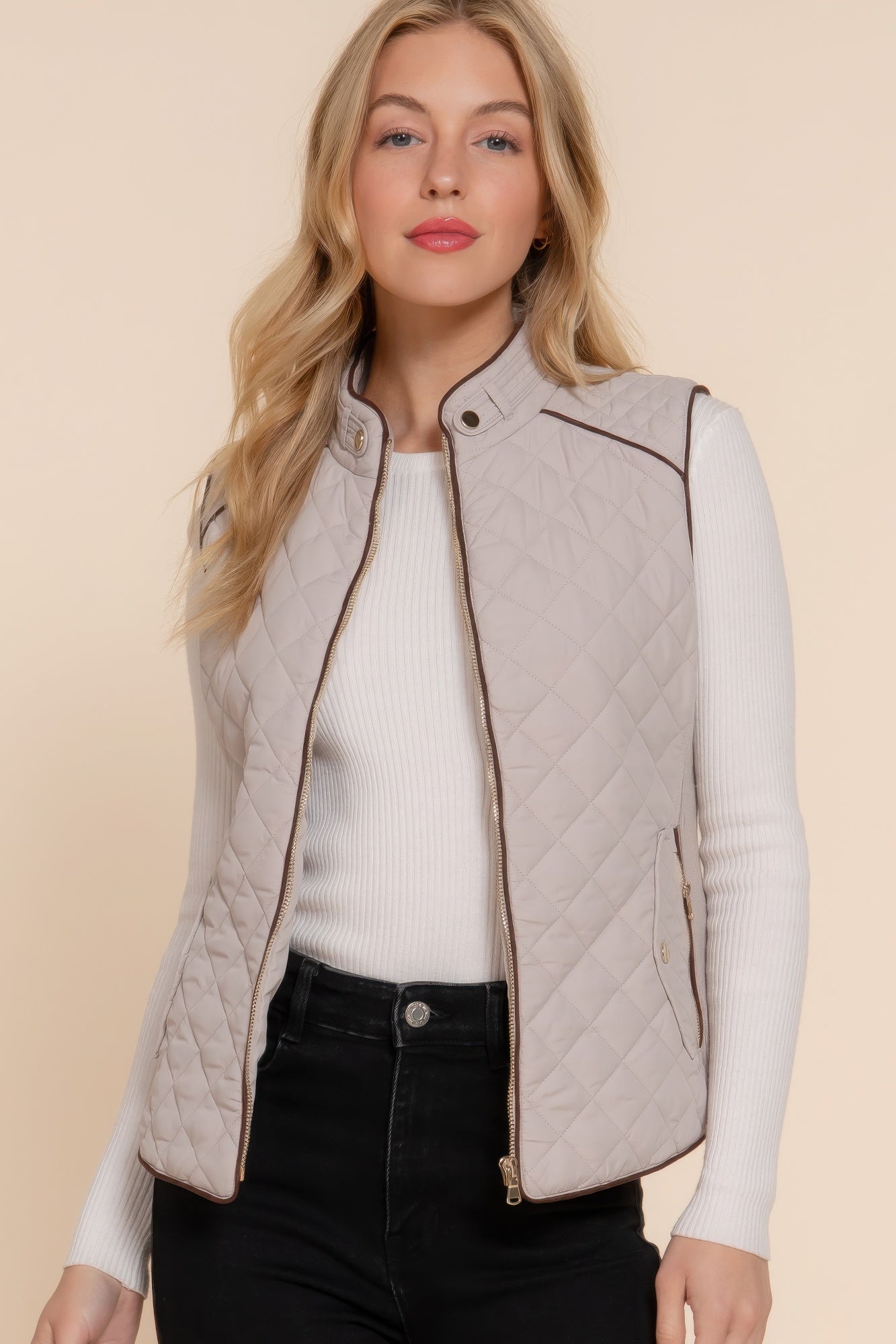 A stylish Suede Piping Quilted Padding Vest in Pale Taupe color, featuring suede piping details and front pockets, perfect for layering.