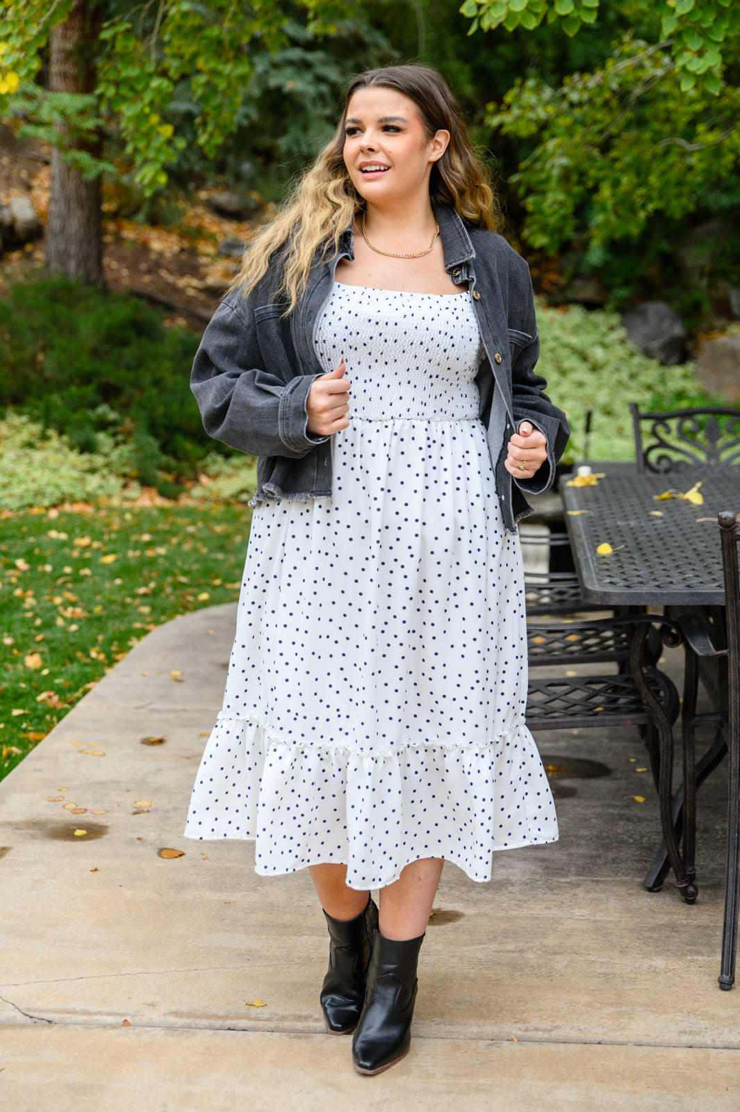 A stylish Sunday Market Dress featuring a square neckline, smocked bodice, slight puff sleeves, and a flowy A-line midi skirt with a ruffle hem.