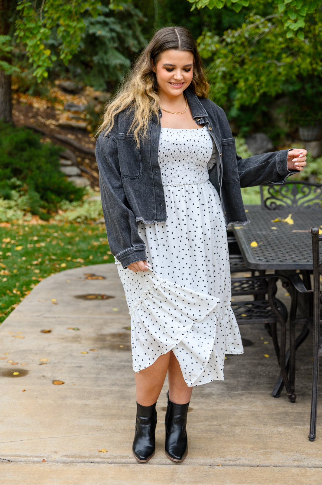 A stylish Sunday Market Dress featuring a square neckline, smocked bodice, slight puff sleeves, and a flowy A-line midi skirt with a ruffle hem.