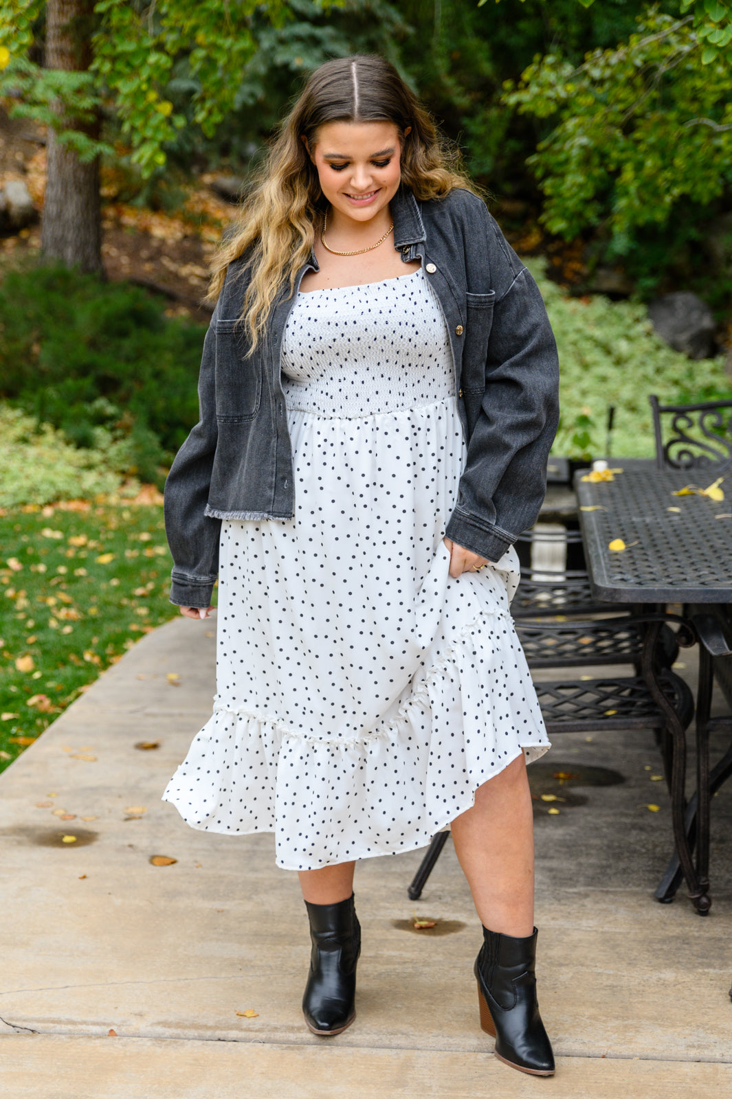 A stylish Sunday Market Dress featuring a square neckline, smocked bodice, slight puff sleeves, and a flowy A-line midi skirt with a ruffle hem.