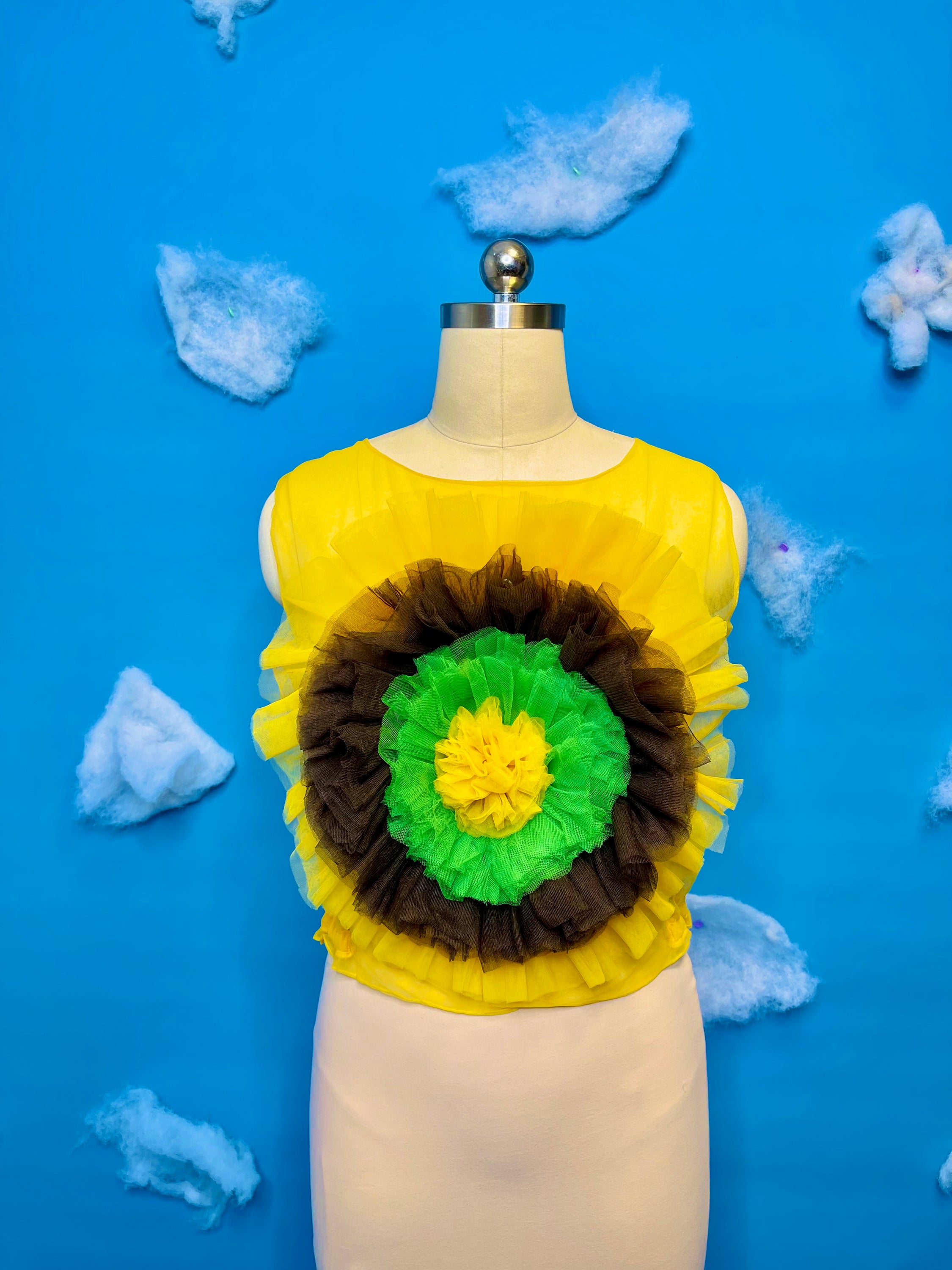 A vibrant sunflower blossom top featuring a cheerful floral design, perfect for adding a pop of color to any outfit.