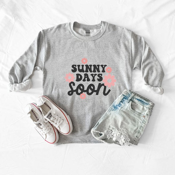 A cozy Gildan unisex sweatshirt featuring a vibrant floral graphic and the phrase 'Sunny Days Soon', perfect for casual wear.