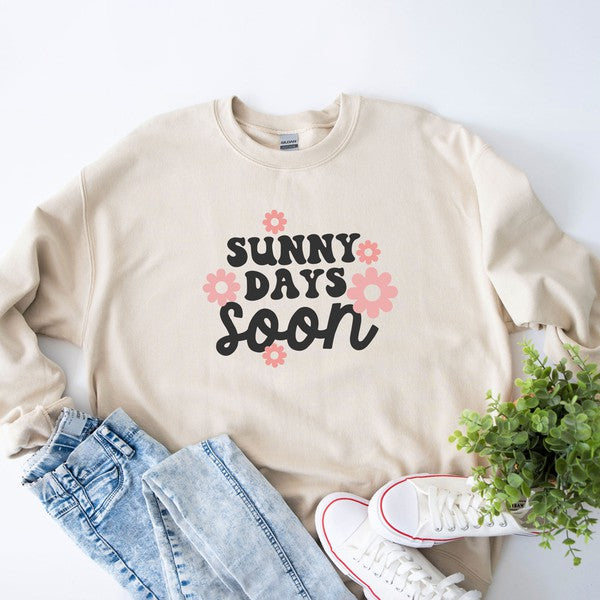 A cozy Gildan unisex sweatshirt featuring a vibrant floral graphic and the phrase 'Sunny Days Soon', perfect for casual wear.