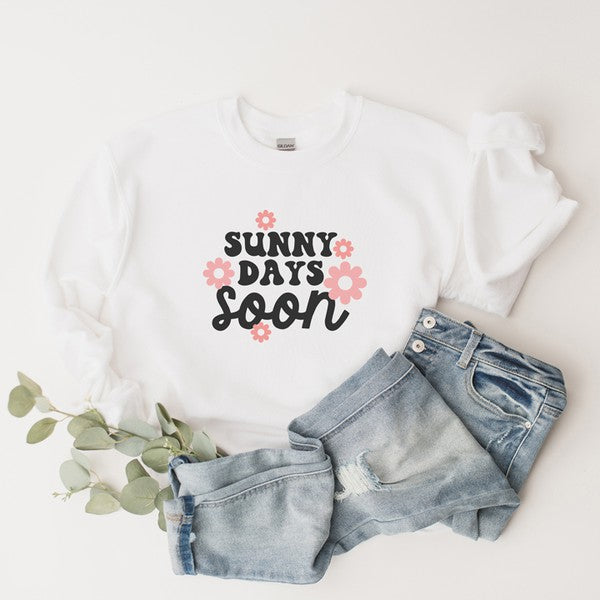 A cozy Gildan unisex sweatshirt featuring a vibrant floral graphic and the phrase 'Sunny Days Soon', perfect for casual wear.