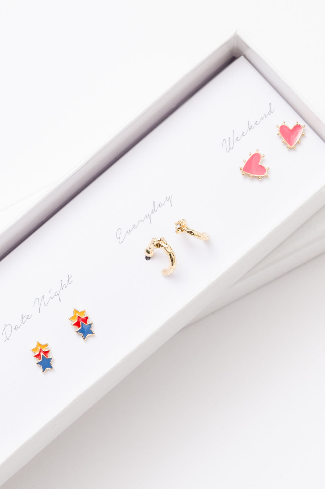 Five pairs of gold earrings in a stylish box, designed for various occasions.