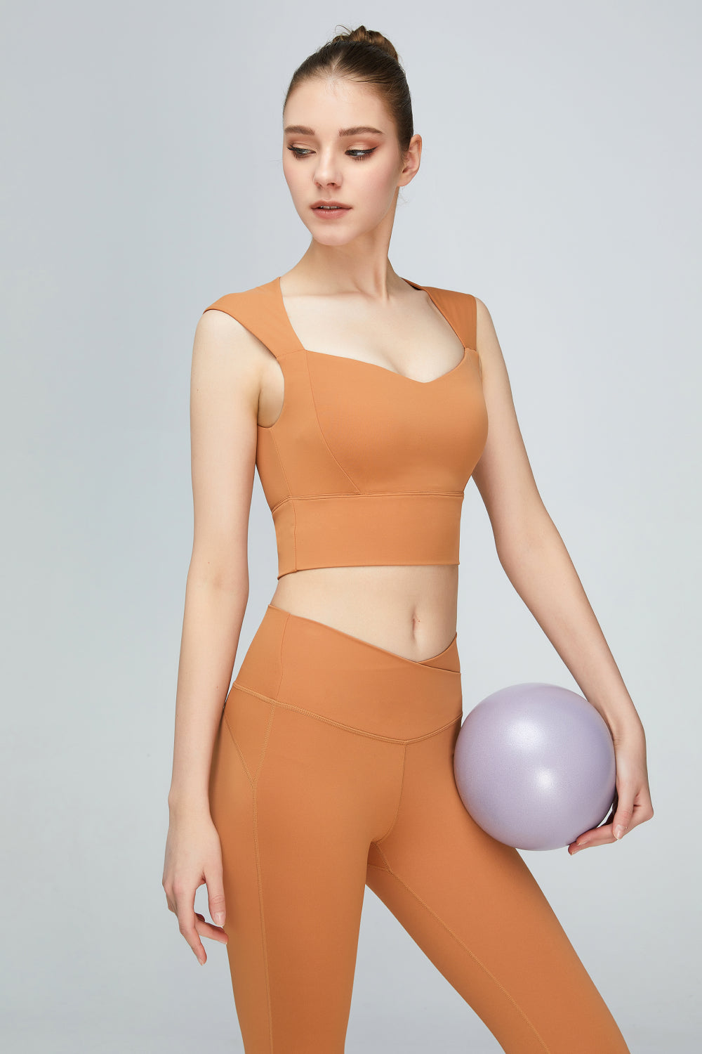 A stylish sweat absorbing sleeveless sports bra in solid color, featuring a Queen Anne neckline and unremovable padding, perfect for yoga and active wear.