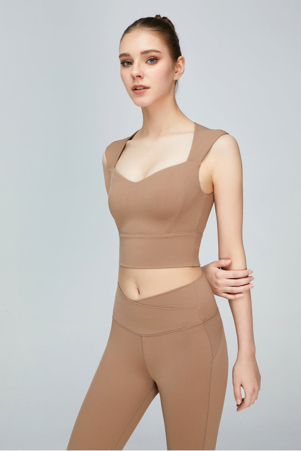 A stylish sweat absorbing sleeveless sports bra in solid color, featuring a Queen Anne neckline and unremovable padding, perfect for yoga and active wear.