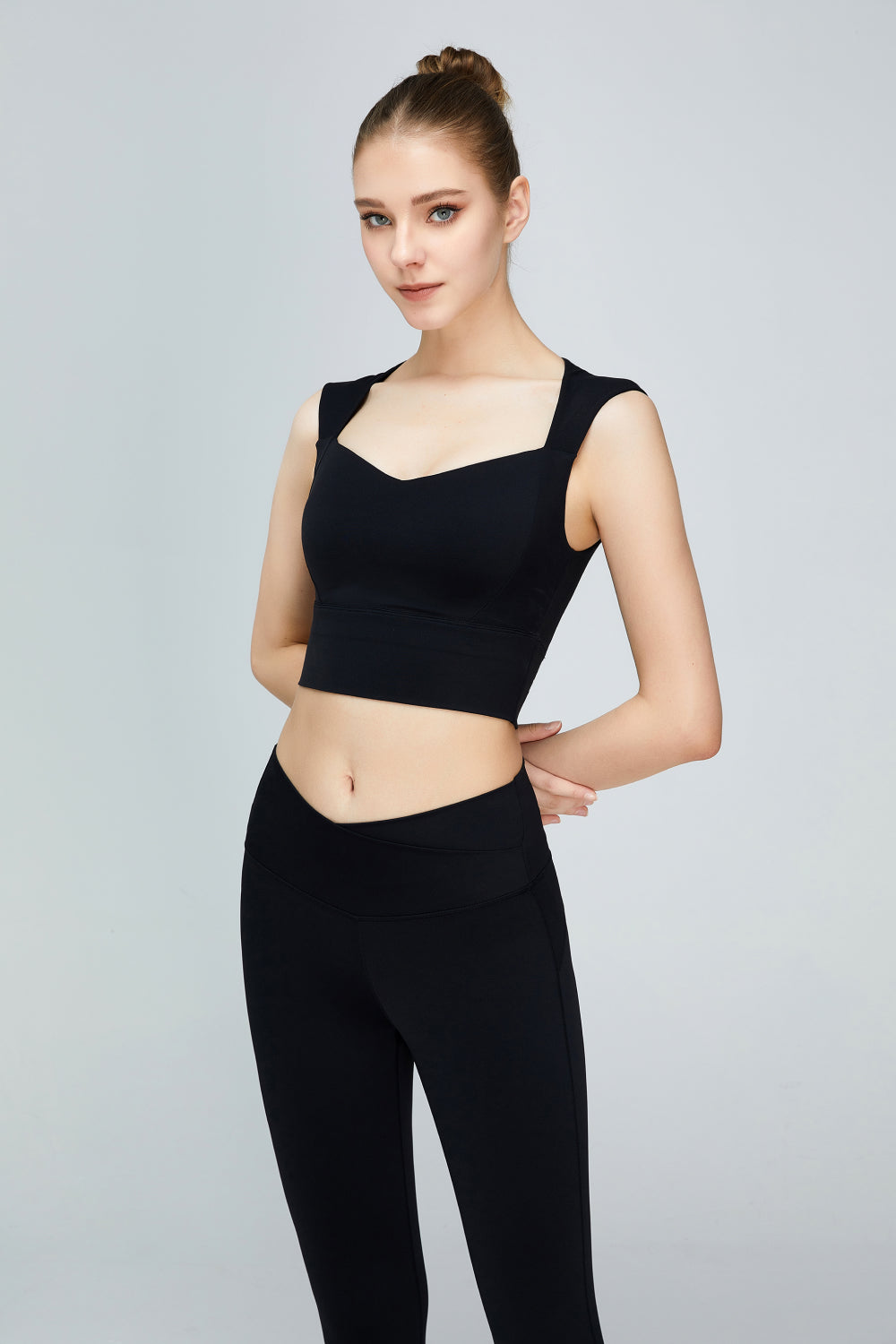 A stylish sweat absorbing sleeveless sports bra in solid color, featuring a Queen Anne neckline and unremovable padding, perfect for yoga and active wear.