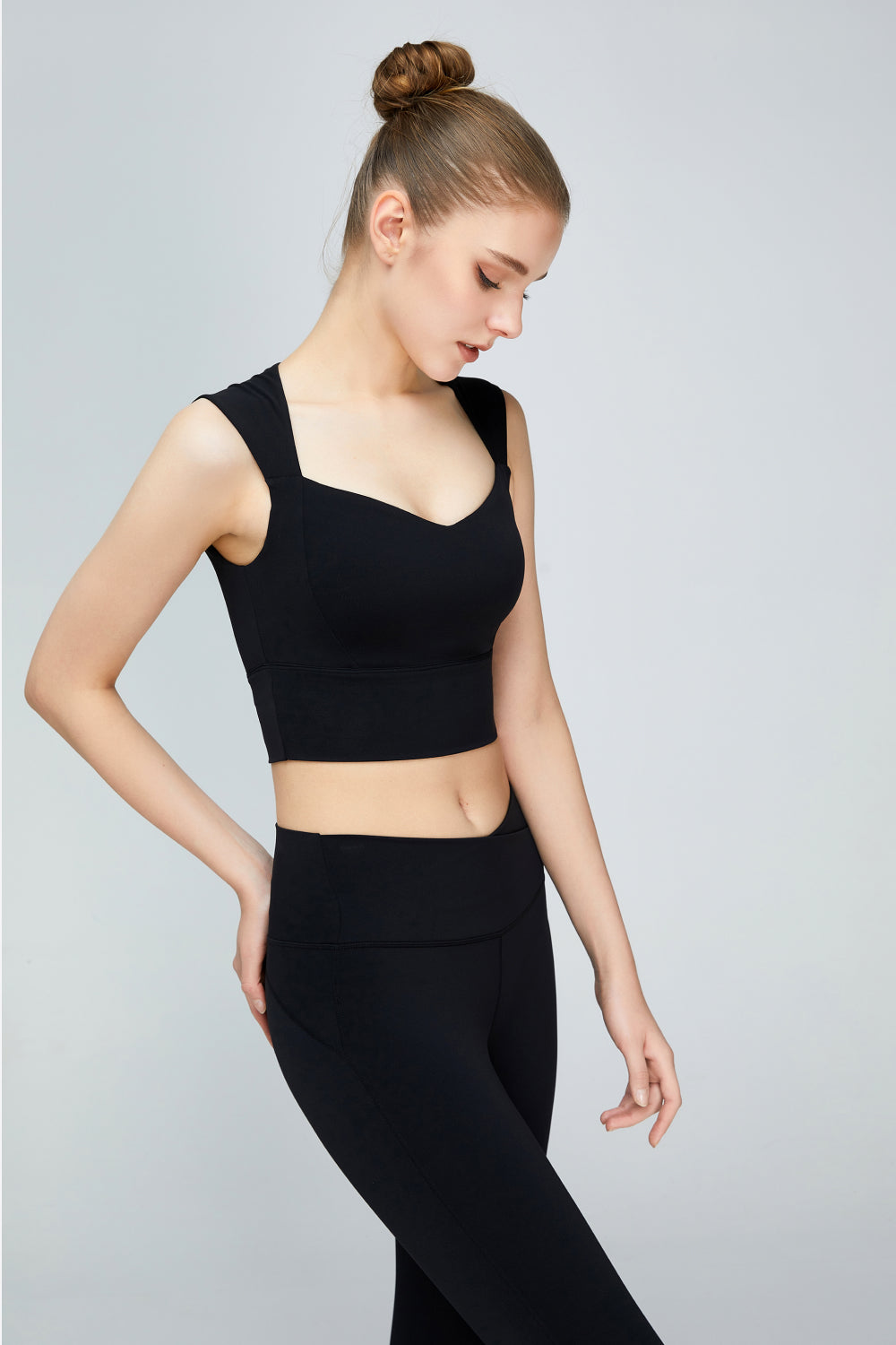 A stylish sweat absorbing sleeveless sports bra in solid color, featuring a Queen Anne neckline and unremovable padding, perfect for yoga and active wear.