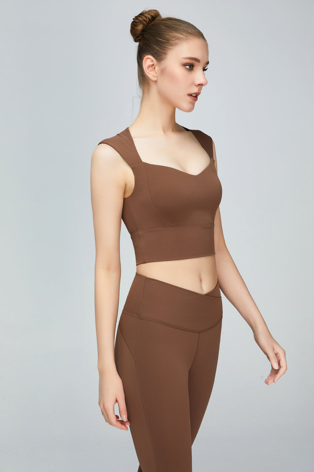 A stylish sweat absorbing sleeveless sports bra in solid color, featuring a Queen Anne neckline and unremovable padding, perfect for yoga and active wear.