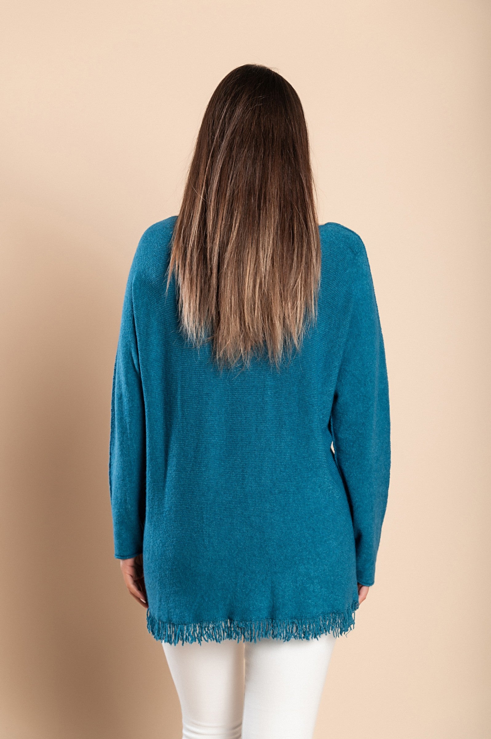 A fashionable petrol sweater with fringes, featuring a V-neckline and long sleeves, made from soft knitwear.