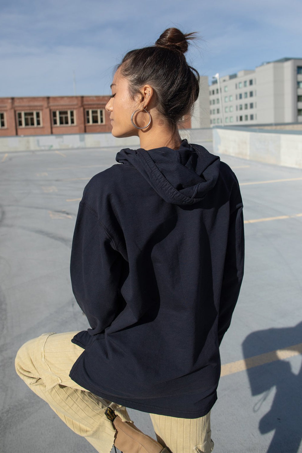 Black Take It Easy Pullover Hoodie with front pockets and cuffed sleeves, featuring a stylish graphic.