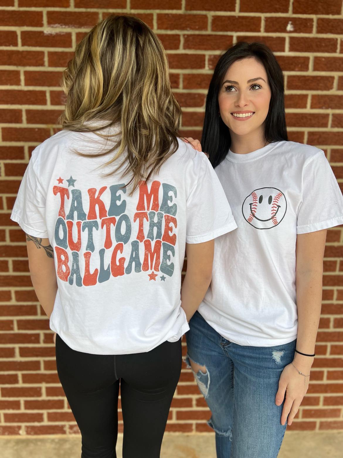 A comfortable white unisex tee with 'Take Me Out To The Ballgame' printed on it, perfect for baseball fans.